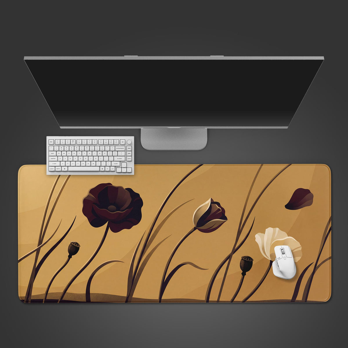 Top view of a gold floral minimalist desk mat with dark poppies and stems under a monitor, white keyboard and white mouse.