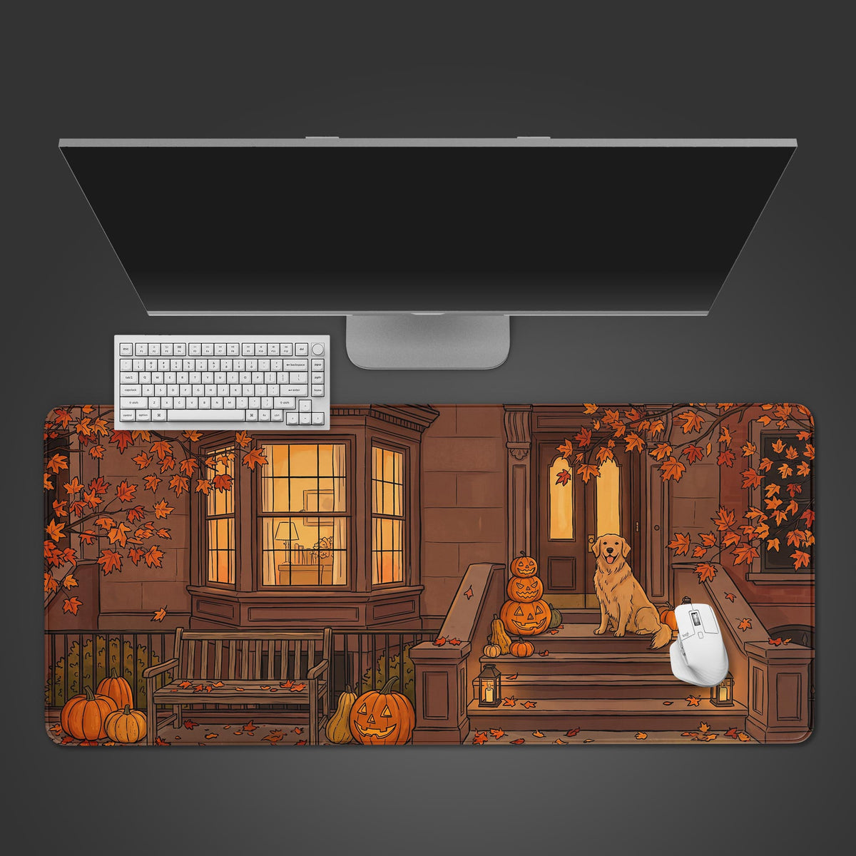 A desk mat featuring a cozy autumn porch scene with a Golden Retriever sitting next to carved glowing pumpkins.