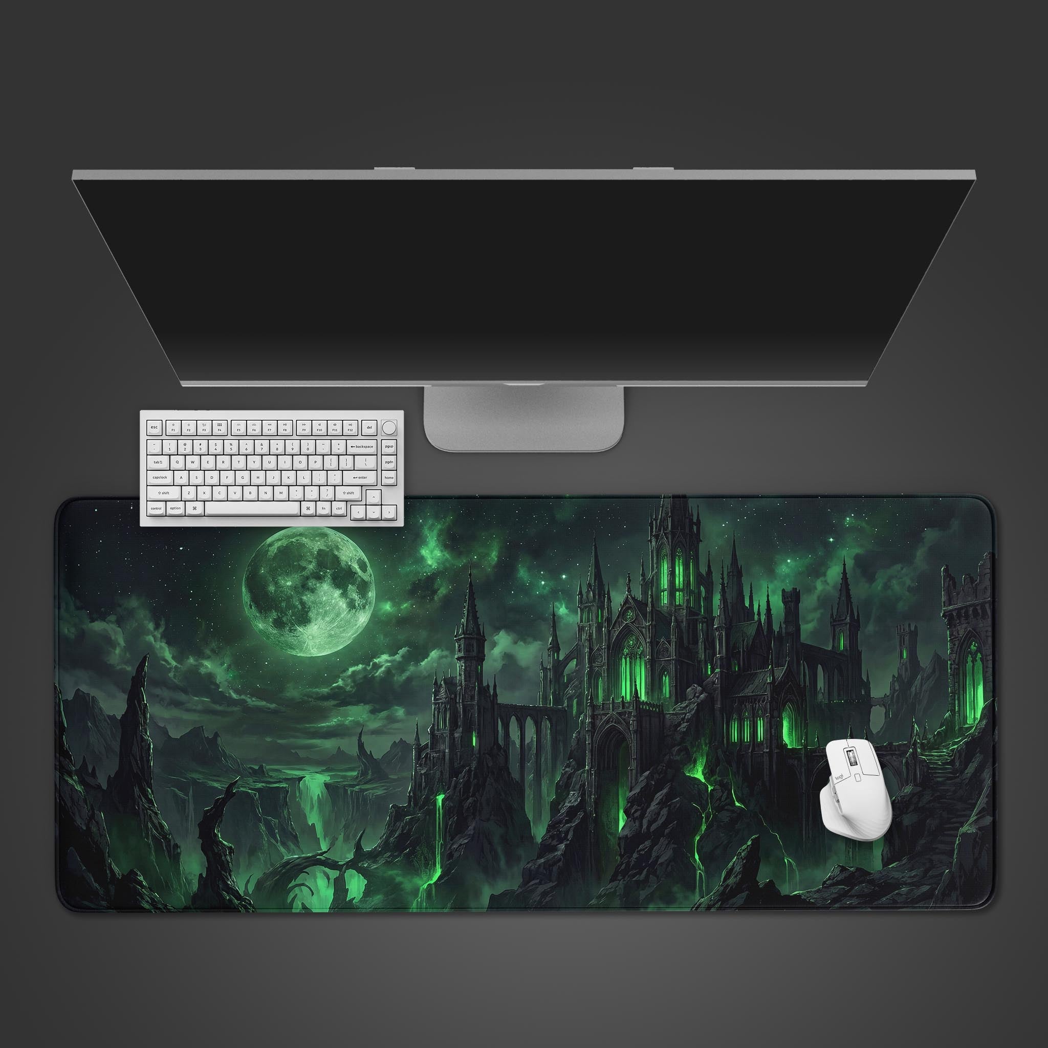 A dark fantasy desk mat featuring a sprawling gothic castle illuminated by eerie green waterfalls under a full moon.