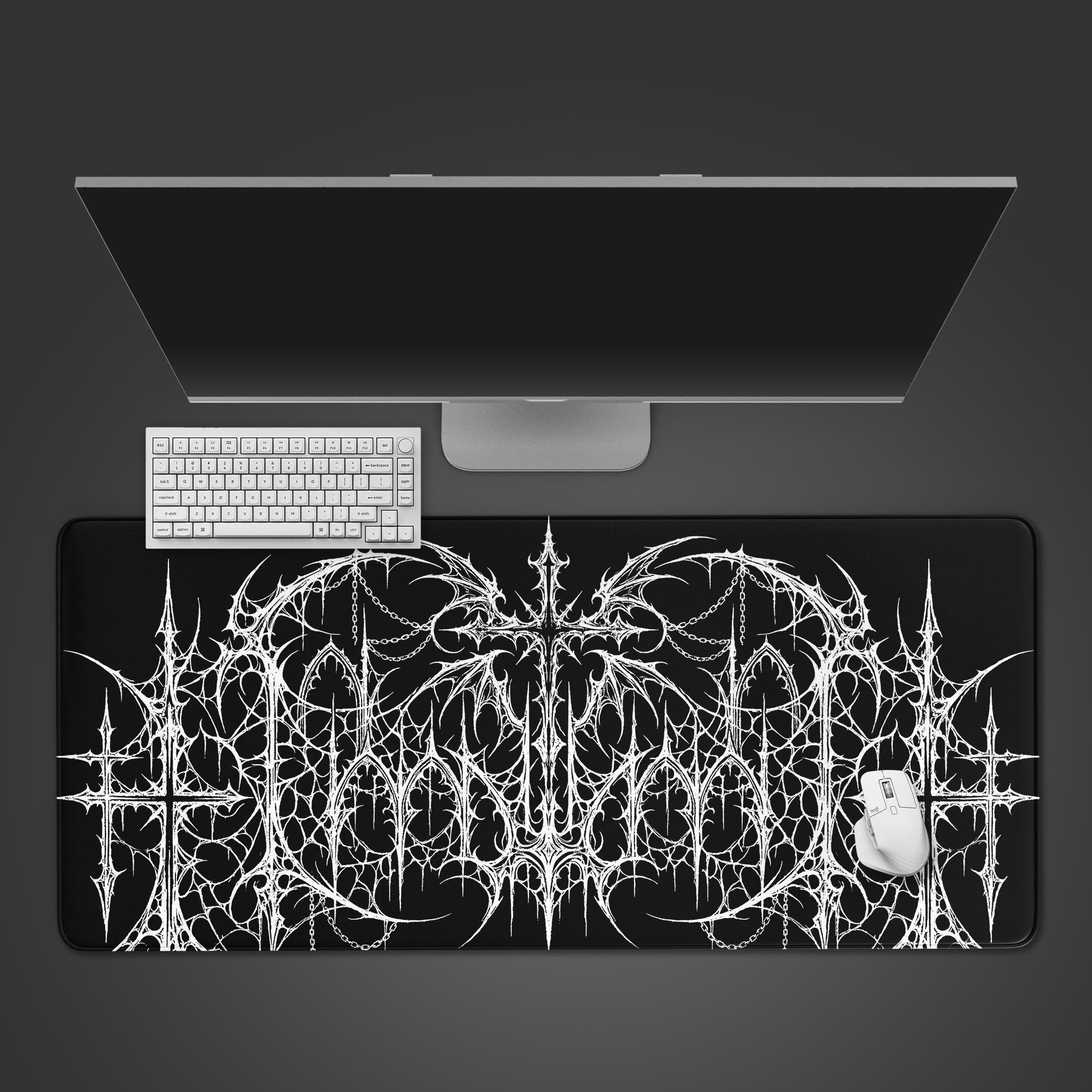 A top-down view of the Gothic Mainframe gaming desk mat, featuring a complex white cyber-gothic design on a black surface, with a white keyboard and mouse. - Epic Design Pads & Mousepads
