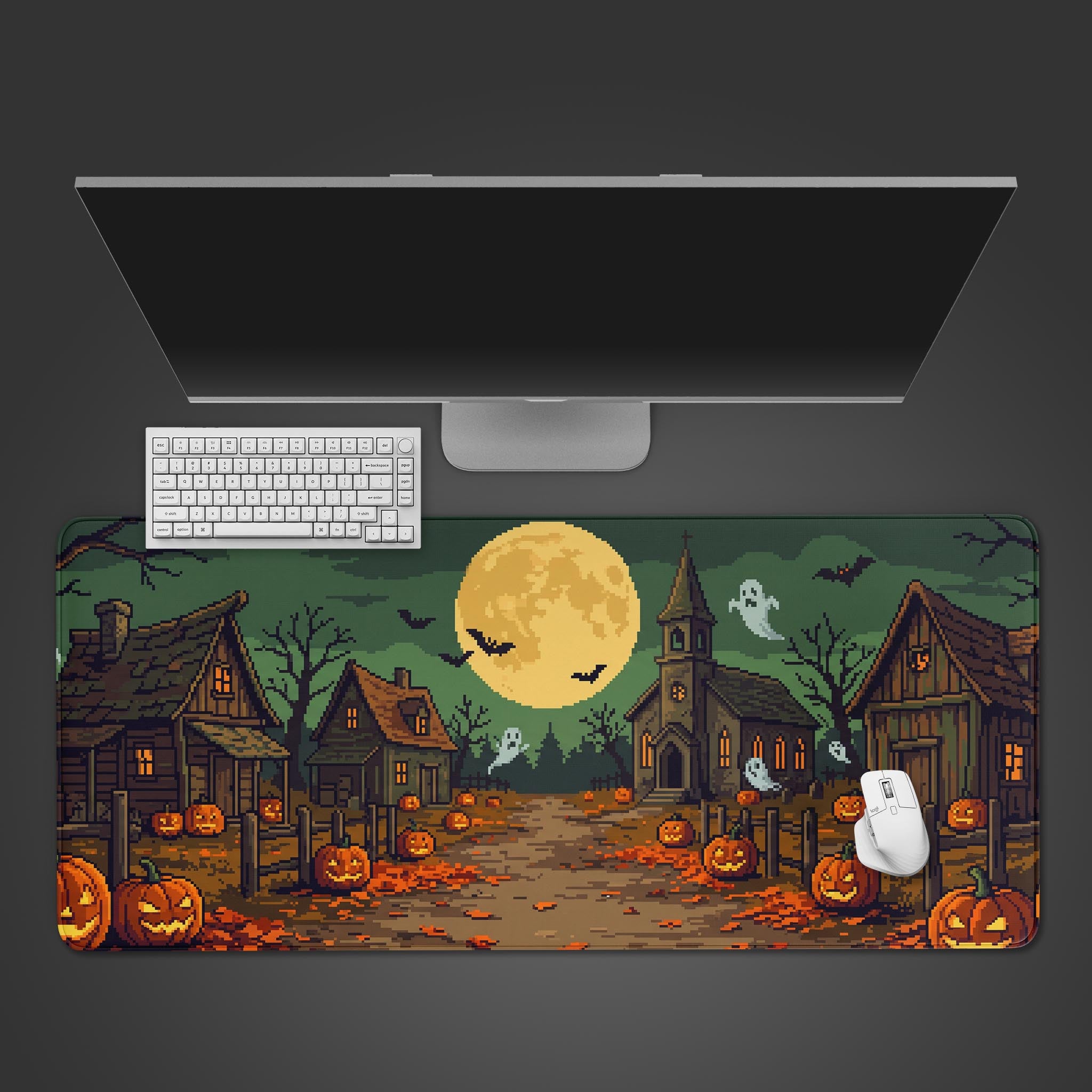 Pixel art Halloween village desk mat with glowing pumpkins, ghosts, and a full moon