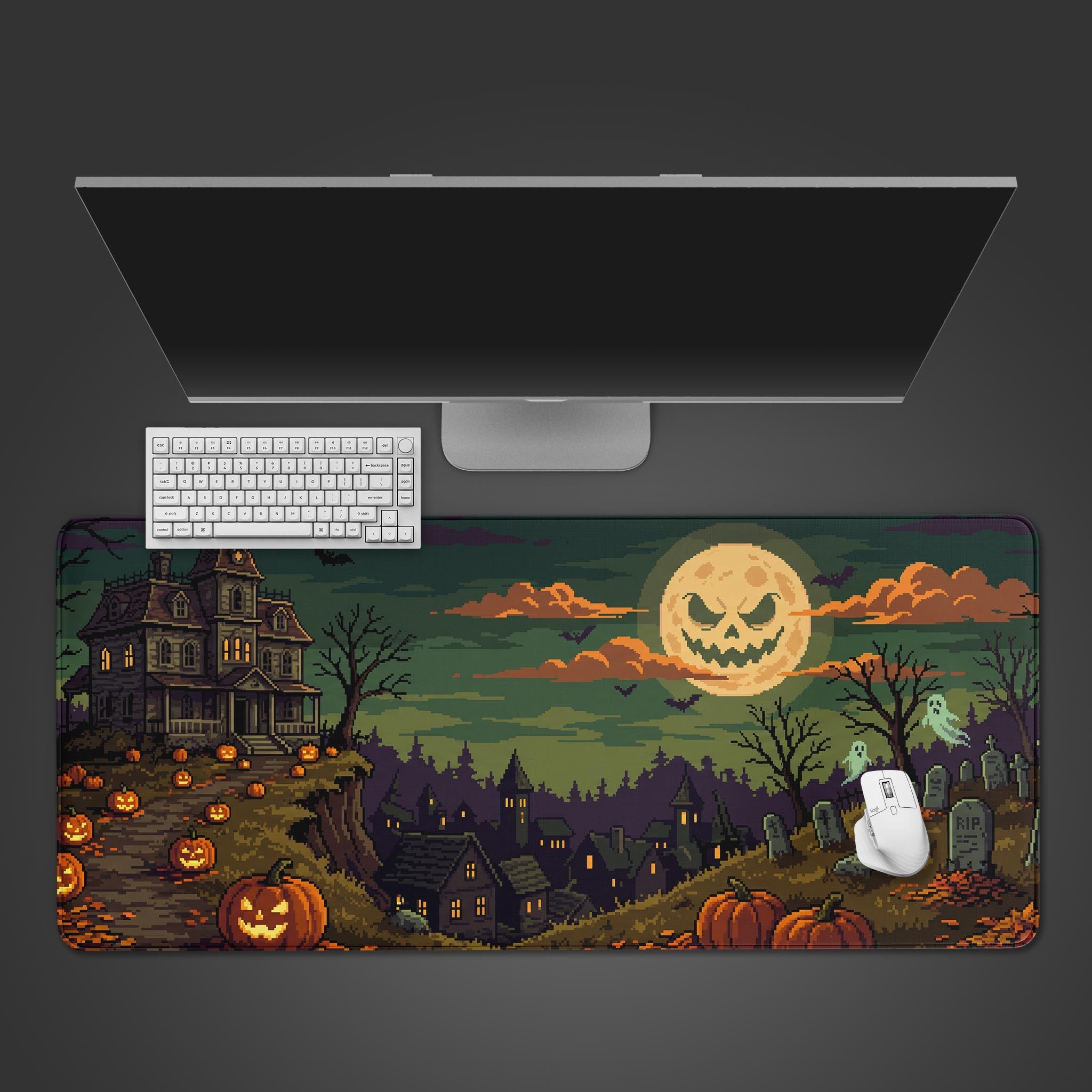 Pixel art Halloween desk mat featuring a haunted house, grinning moon, and glowing pumpkins