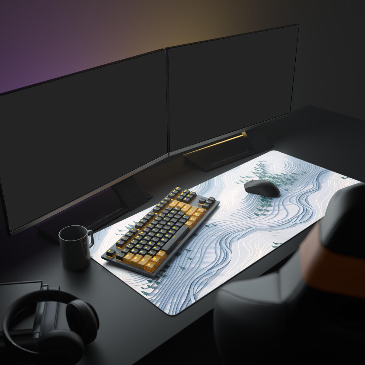 Desk mat on a dark desk under two monitors with a black and orange keyboard, mouse and mug on white contours and pines