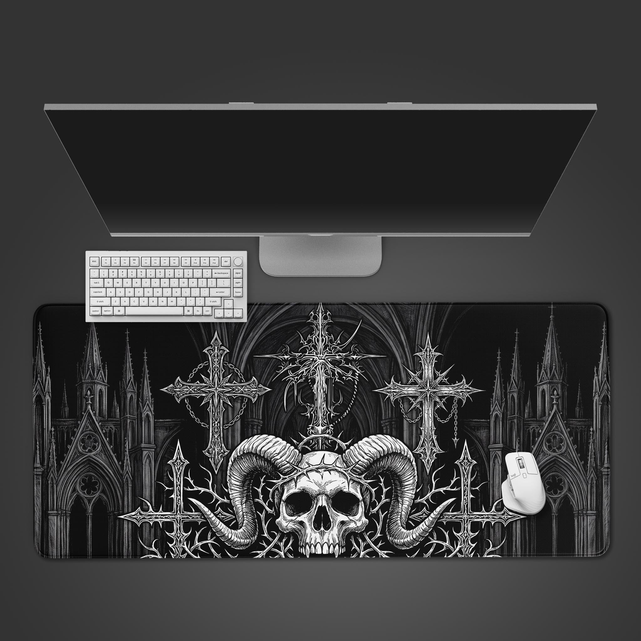 A black and white desk mat featuring a detailed horned skull in front of ornate crosses and a gothic cathedral.