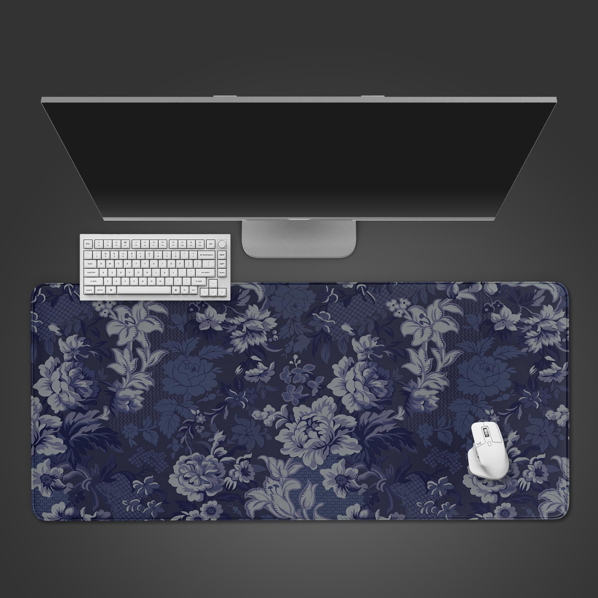 Top-down view of the Indigo Baroque gaming desk mat, featuring a dark blue and grey floral pattern with a white keyboard and mouse. - Epic Design Pads & Mousepads