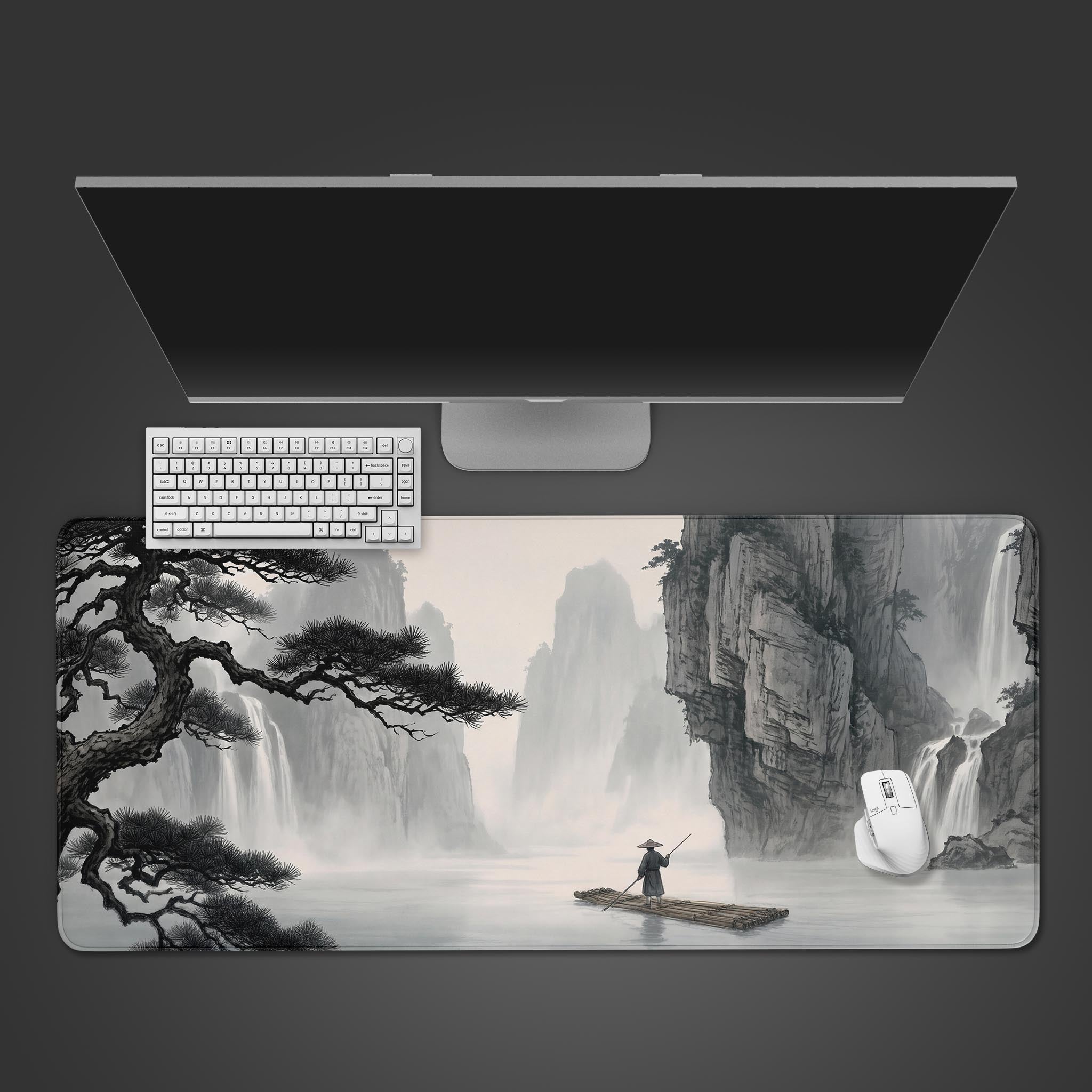 Desk mat displaying a traditional black and white ink wash painting of towering mountains and waterfalls.