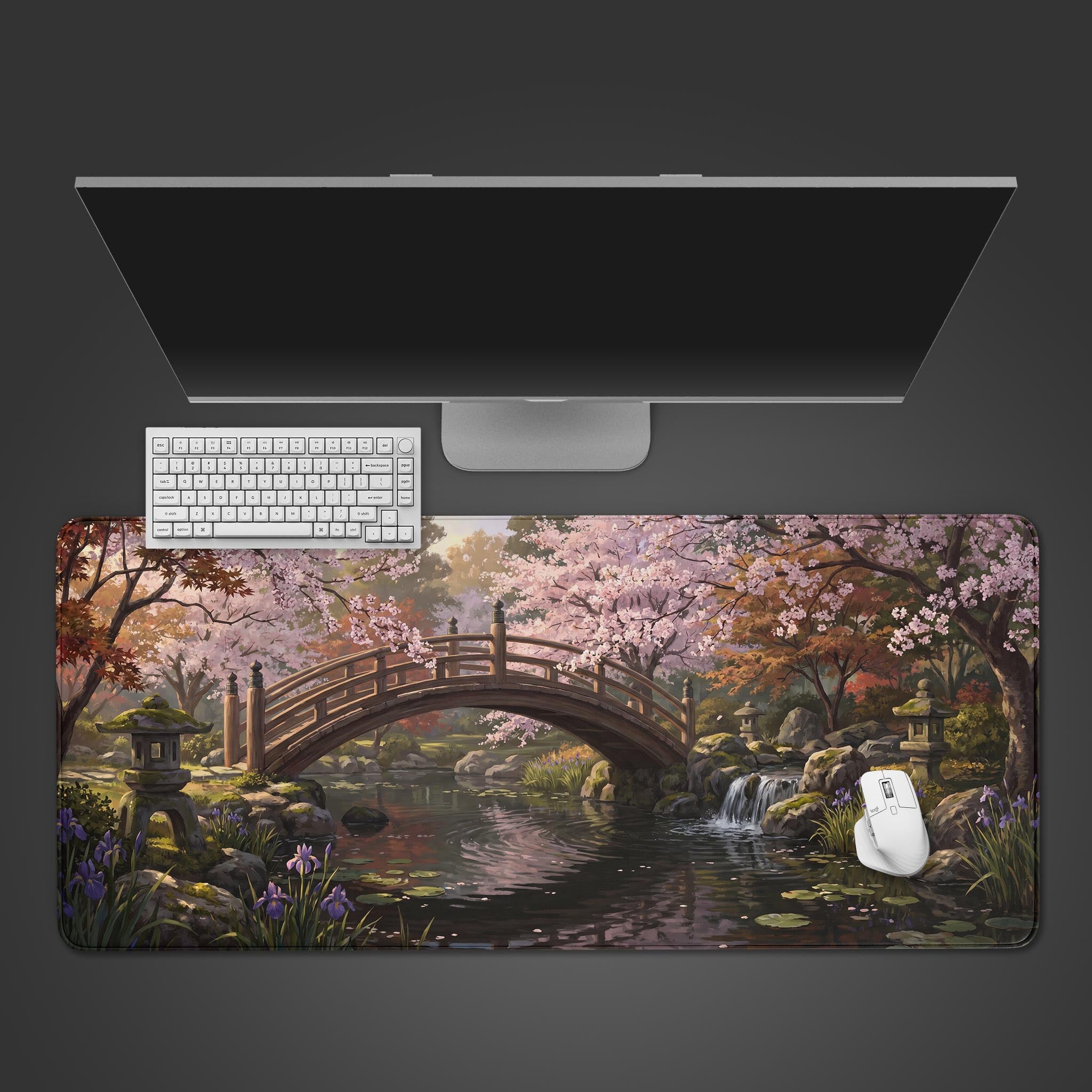 A serene Japanese garden desk mat featuring a wooden bridge over a pond surrounded by cherry blossoms.