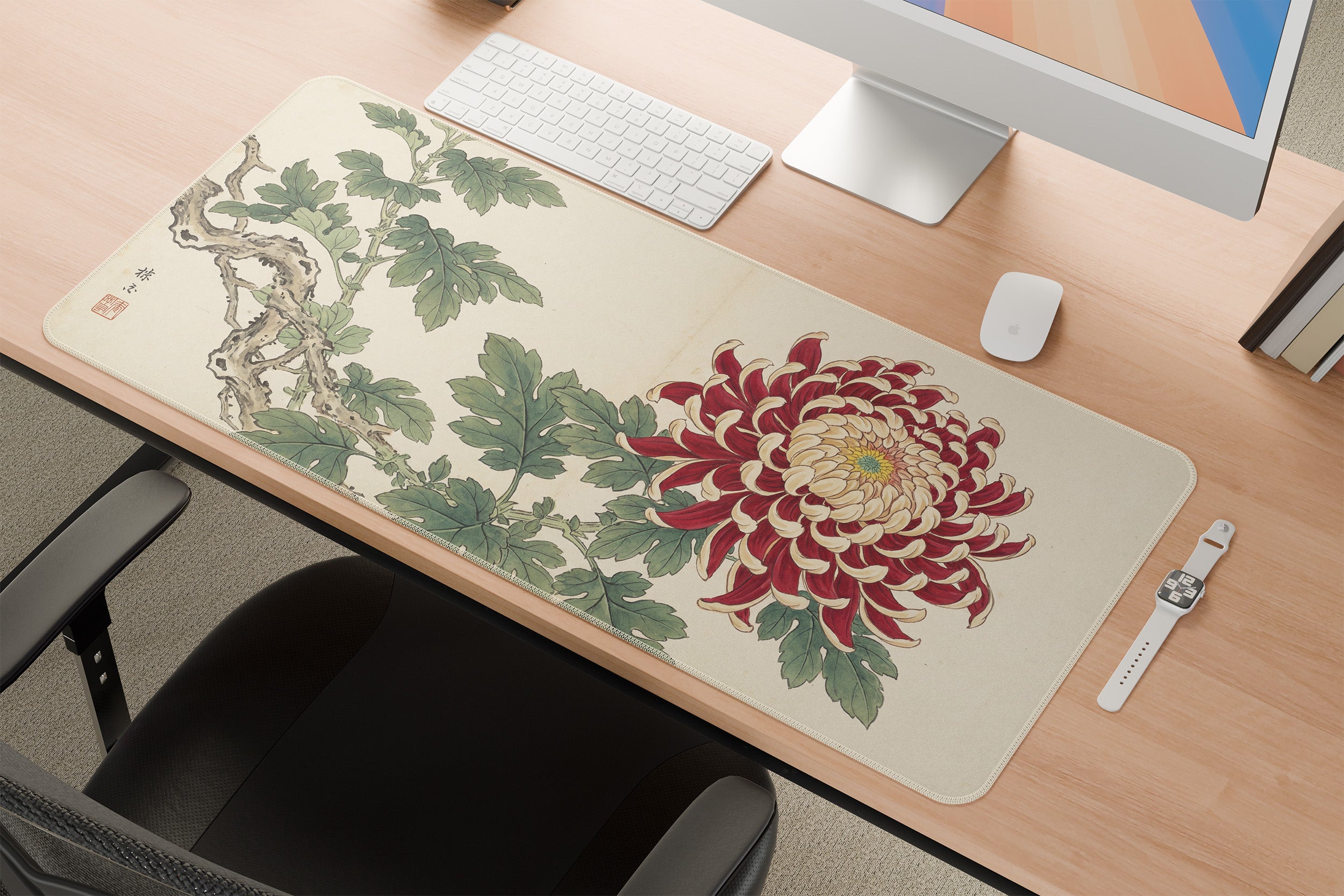 Decorative desk mat with Japanese kiku floral design on a desk setup