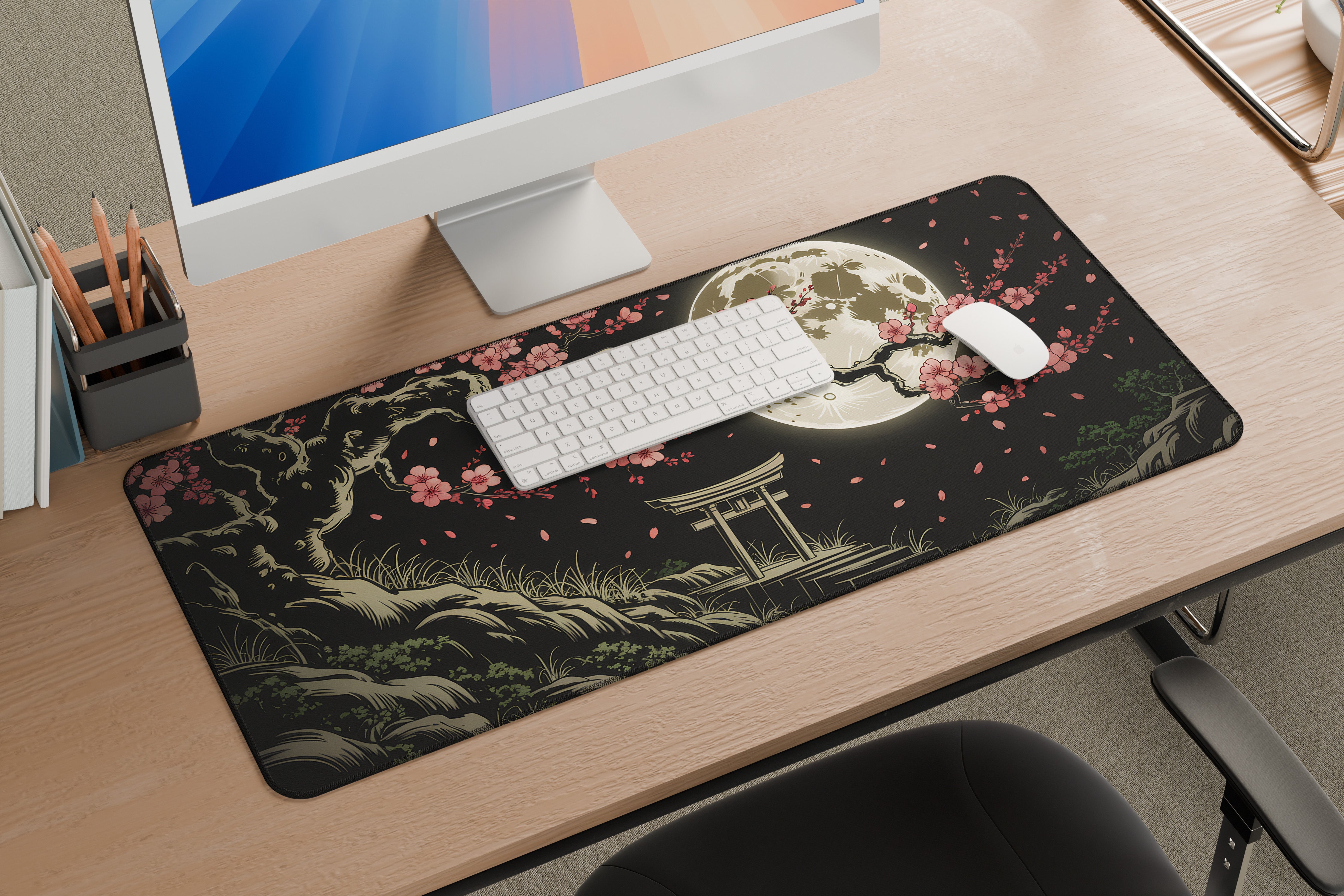 Decorative mouse pad with a Japanese-style design on a desk with a computer setup.