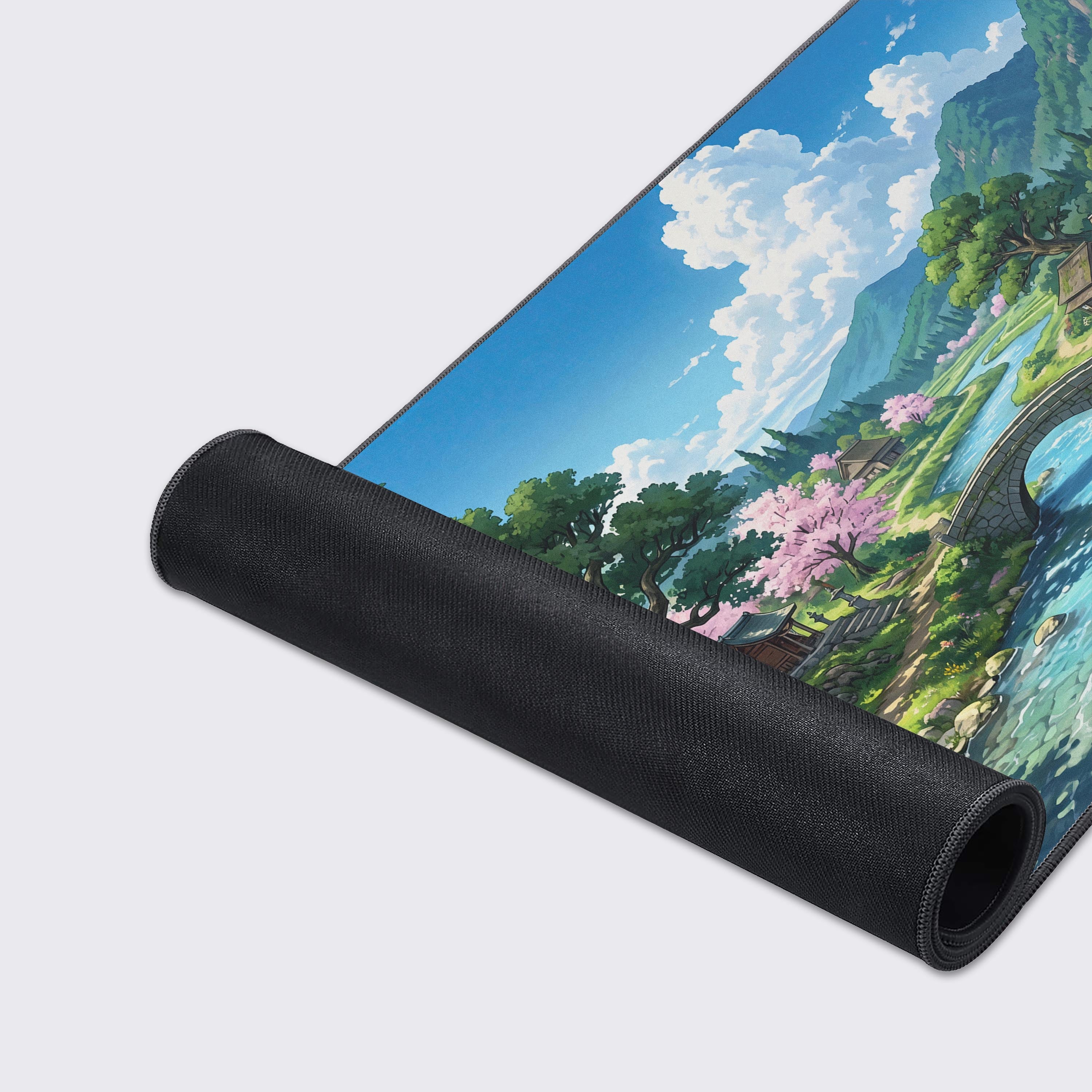 Large desk mat displaying a lush green countryside, flowing river, and traditional wooden houses.