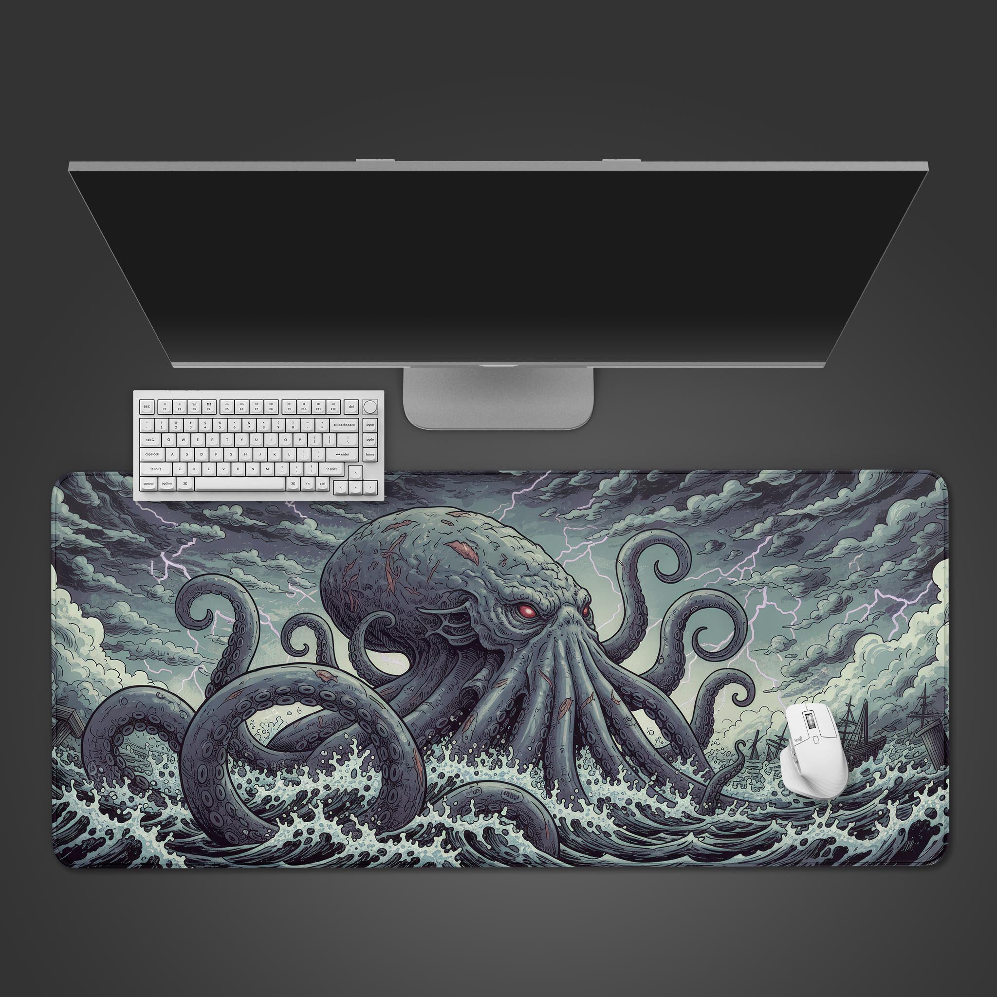 Kraken's Fury gaming desk mat with mythical sea monster design – top-down view on a desk with a keyboard and mouse. - Epic Design Pads