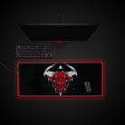 Gaming setup with a large mouse pad featuring a bull design on a dark background