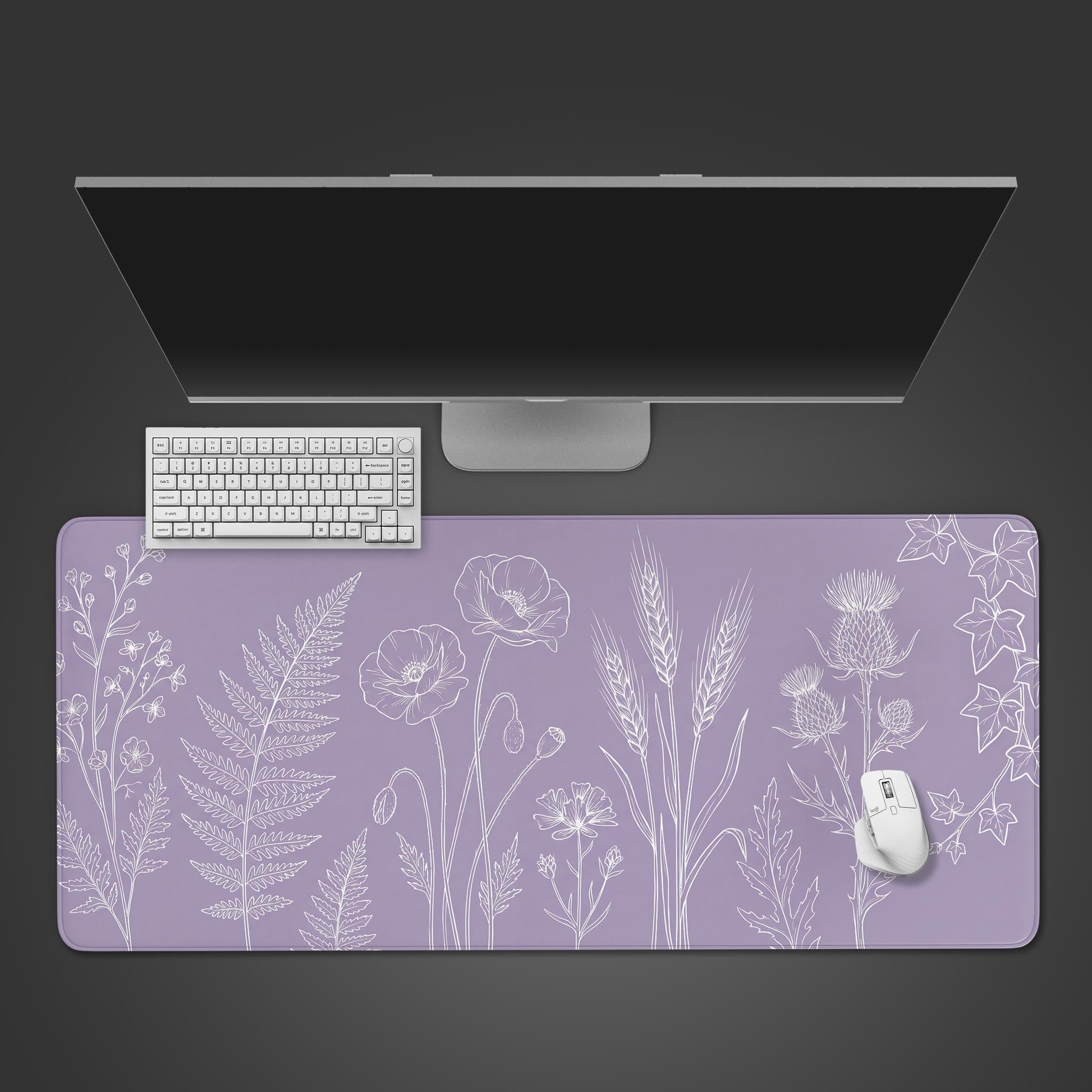 Top-down view of the Lavender Botanica desk mat with white floral line art. A white keyboard and mouse are placed on the purple gaming desk mat below a monitor. - Epic Design Pads & Mousepads