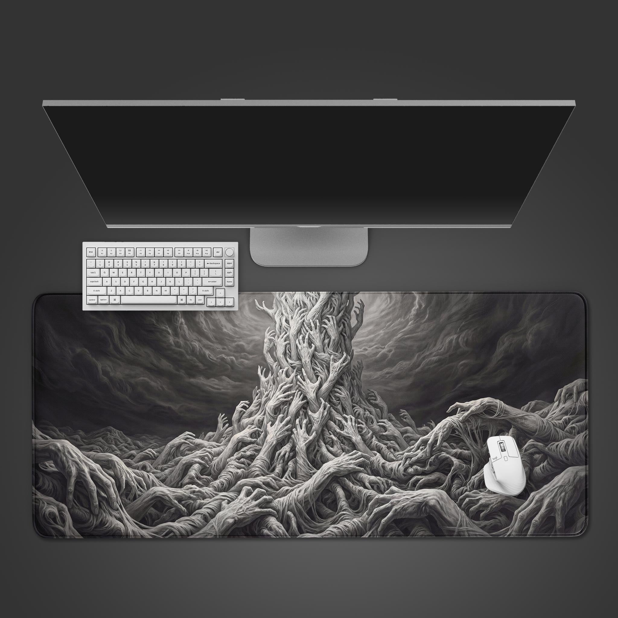 Top-down view of the Legion of Hands gaming desk mat, showing the dark fantasy art of grasping hands alongside a white keyboard, mouse, and monitor on a dark surface. - Epic Design Pads & Mousepads
