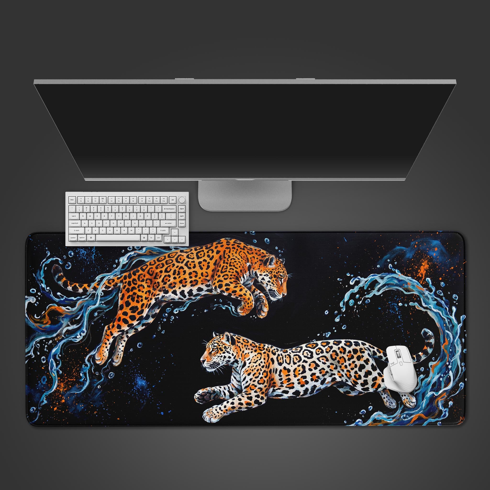 Dynamic leopard desk mat featuring two leaping big cats and splashing water on a black background