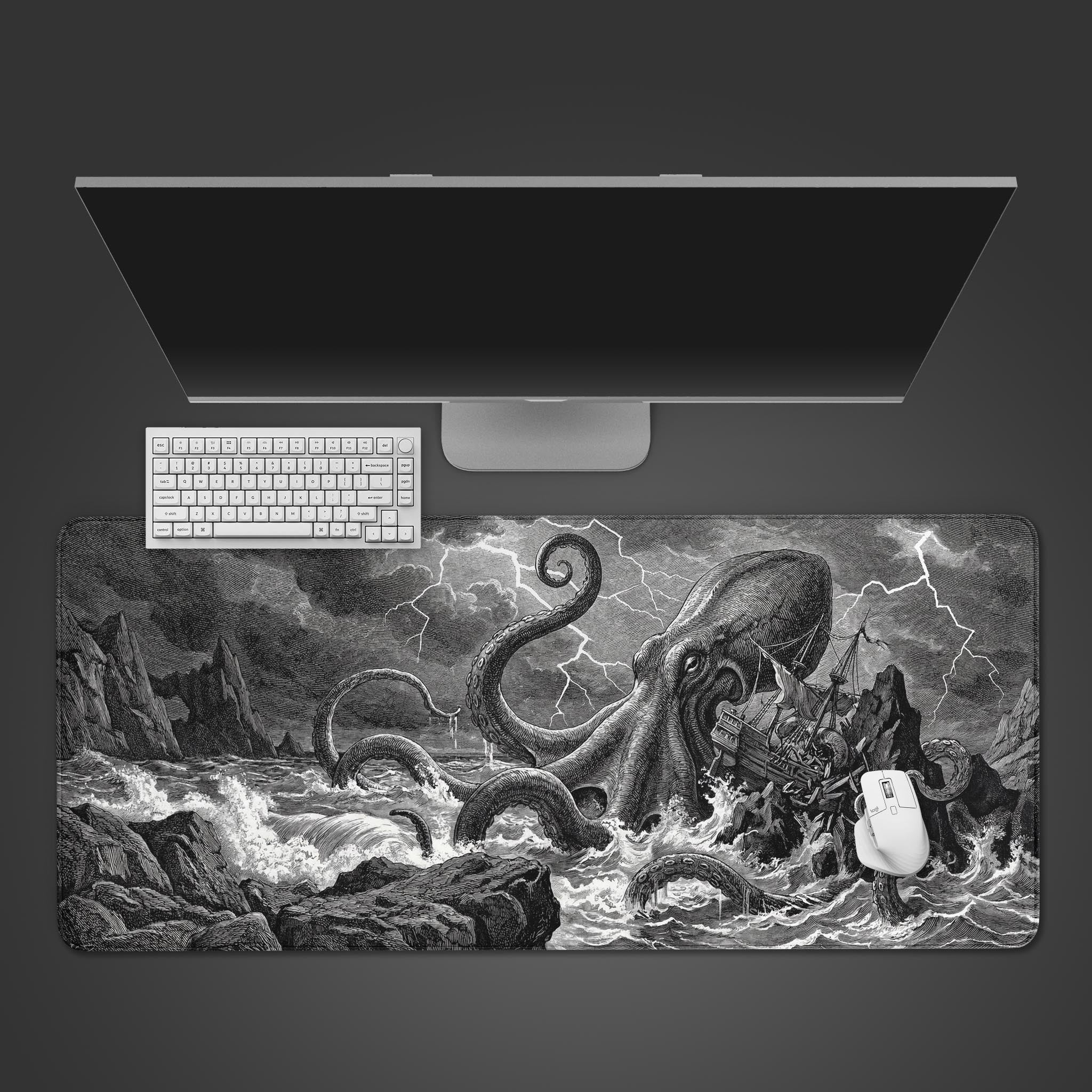 Top-down view of the Leviathan's Wrath gaming desk mat, featuring a Kraken design, a white keyboard, mouse, and a sleek monitor on a dark background. - Epic Design Pads & Mousepads