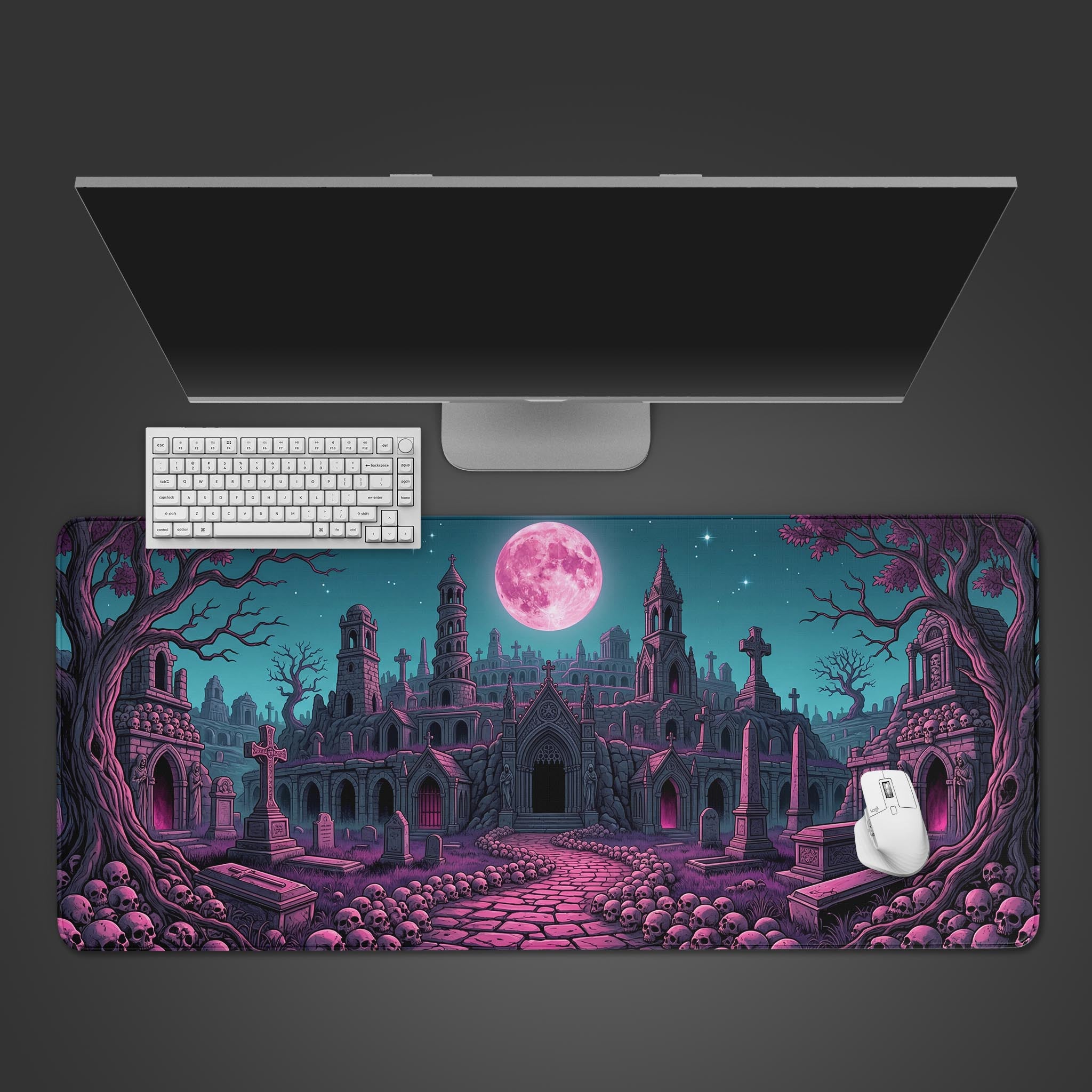 The Lunar Boneyard gaming desk mat shown from a top-down view with a white keyboard and mouse, depicting a gothic graveyard under a large pink moon. - Epic Design Pads & Mousepads