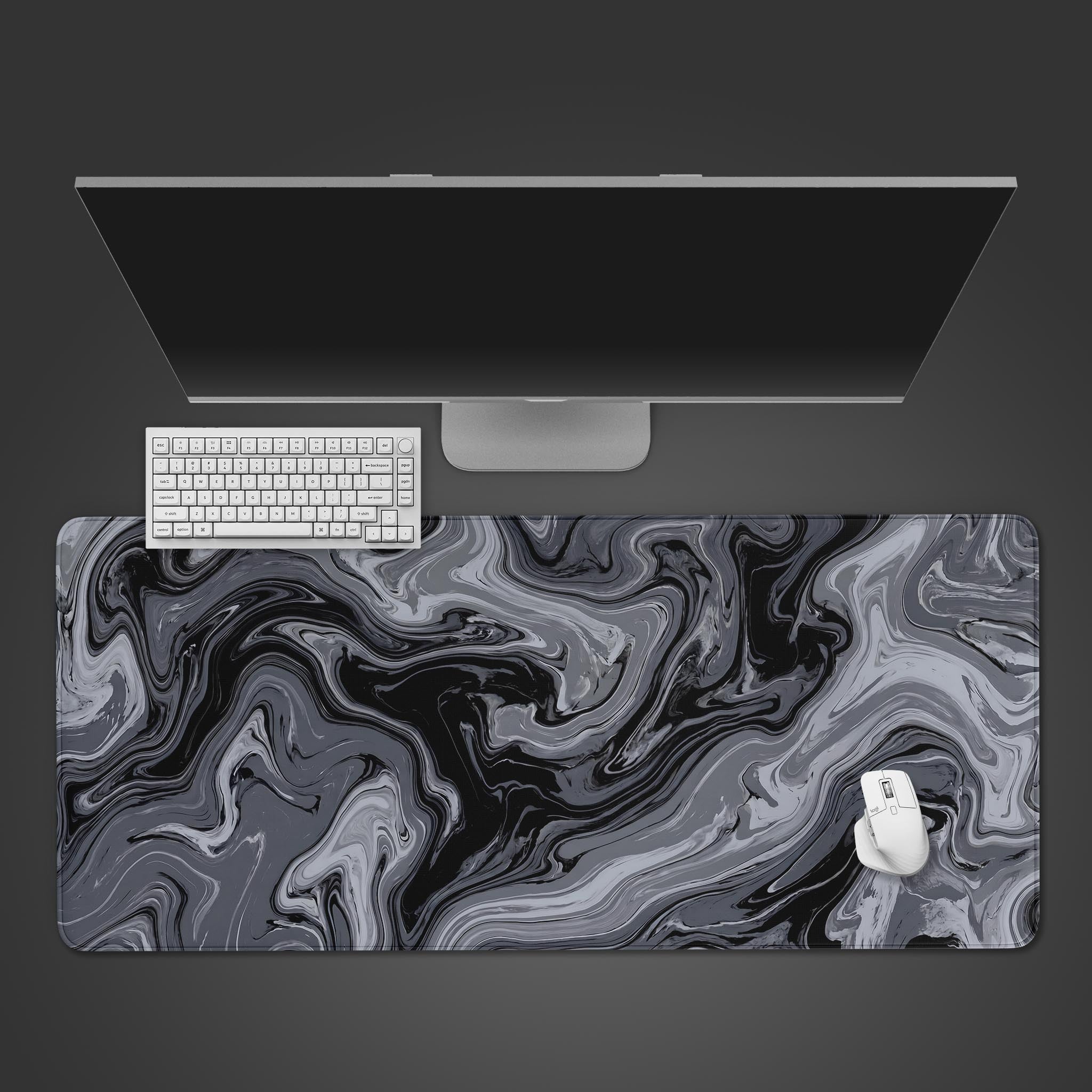 Monochrome black and gray fluid marble desk mat featuring abstract swirls