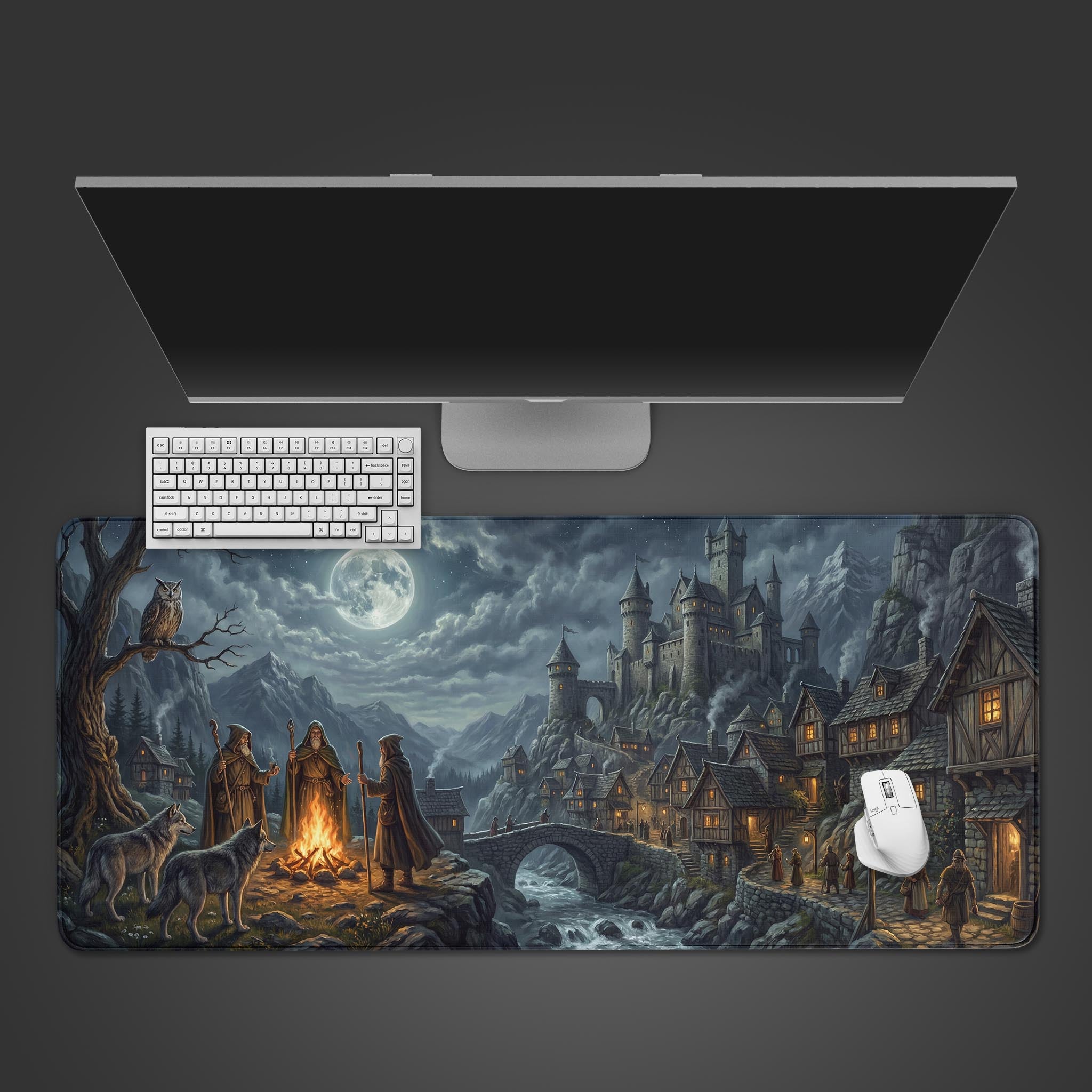 A top-down view of the Midnight Council gaming desk mat. A white keyboard and mouse sit on the dark fantasy design featuring a castle and wizards under a full moon. - Epic Design Pads & Mousepads