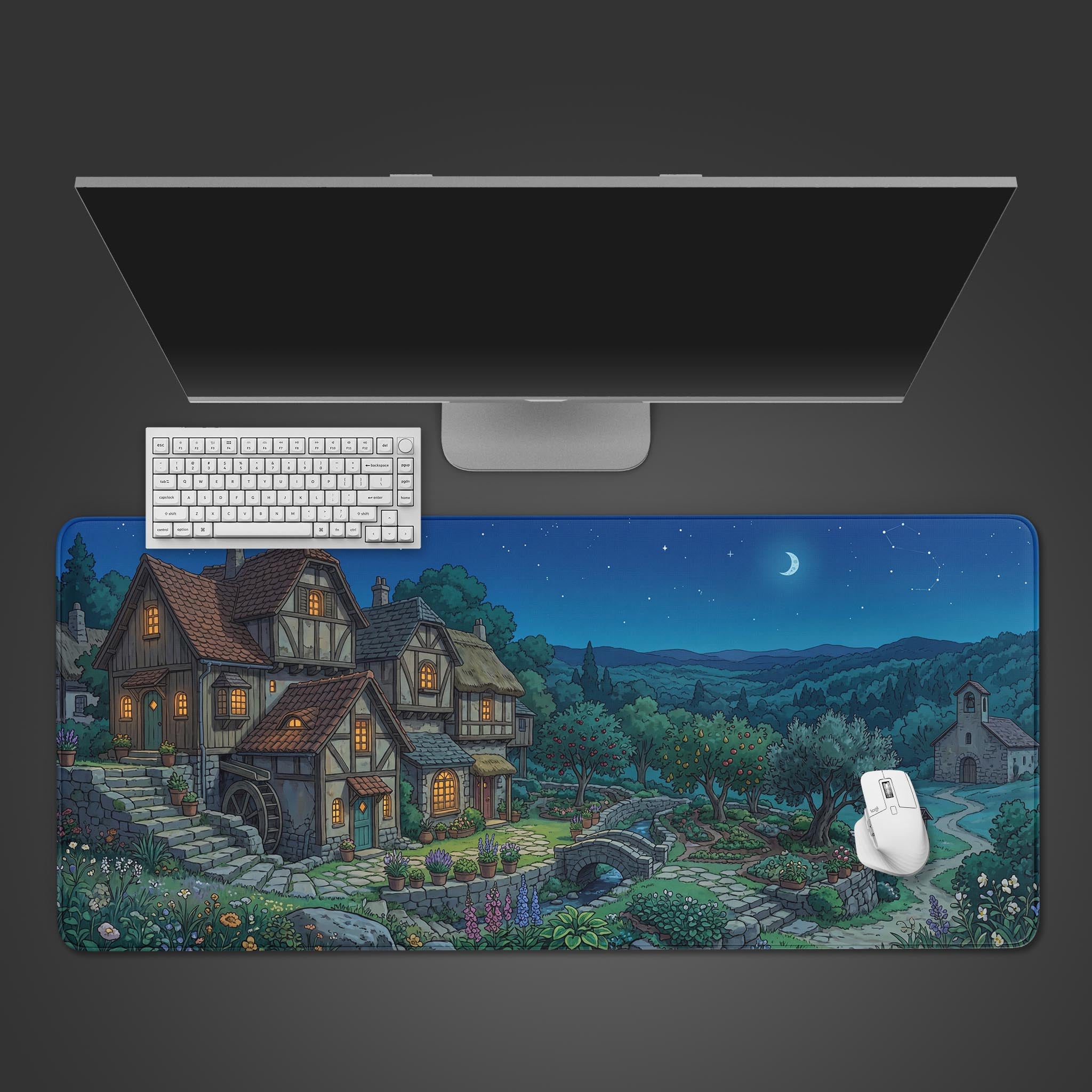 The Midnight Hamlet gaming desk mat viewed from above, showcasing its serene village design beneath a white keyboard, mouse, and monitor on a dark surface. - Epic Design Pads & Mousepads