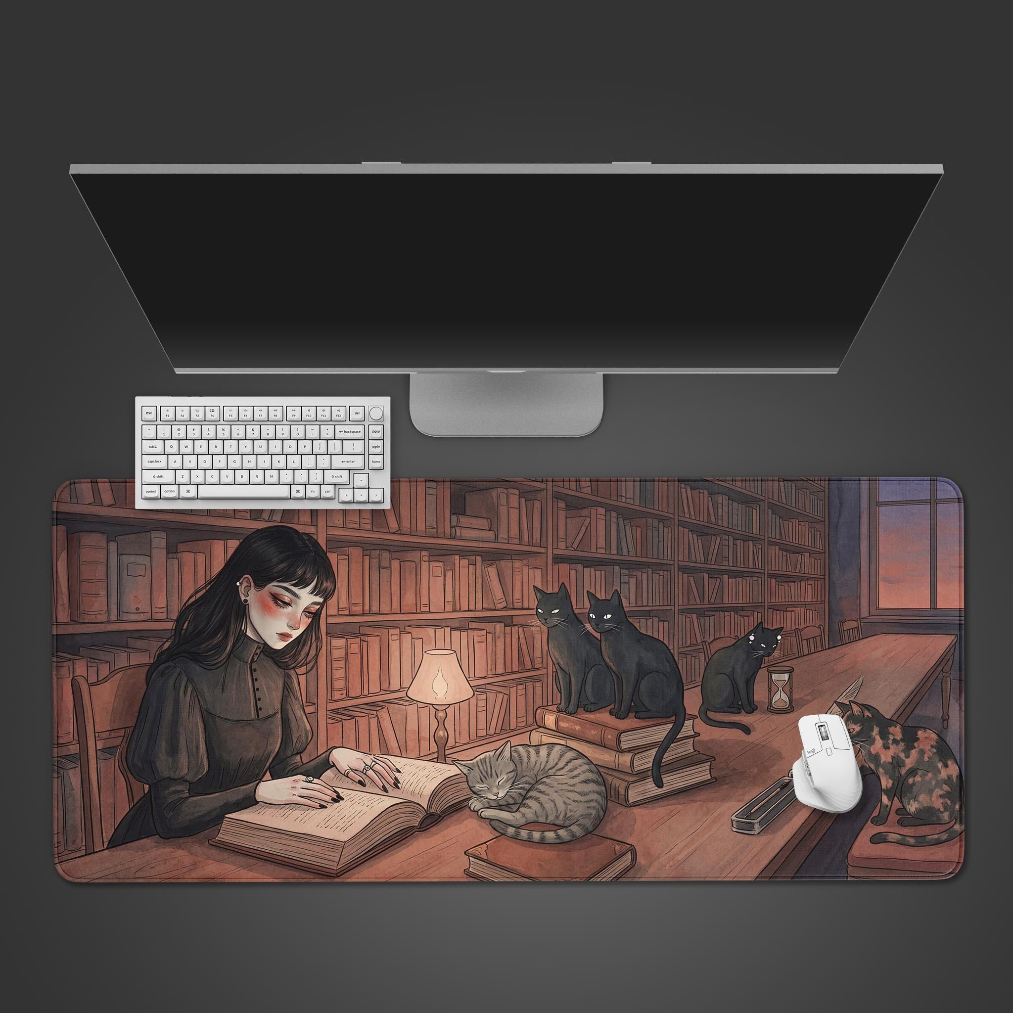 The Midnight Library gaming desk mat shown from a top-down view with a white keyboard and monitor, displaying its dark academia library illustration. - Epic Design Pads & Mousepads