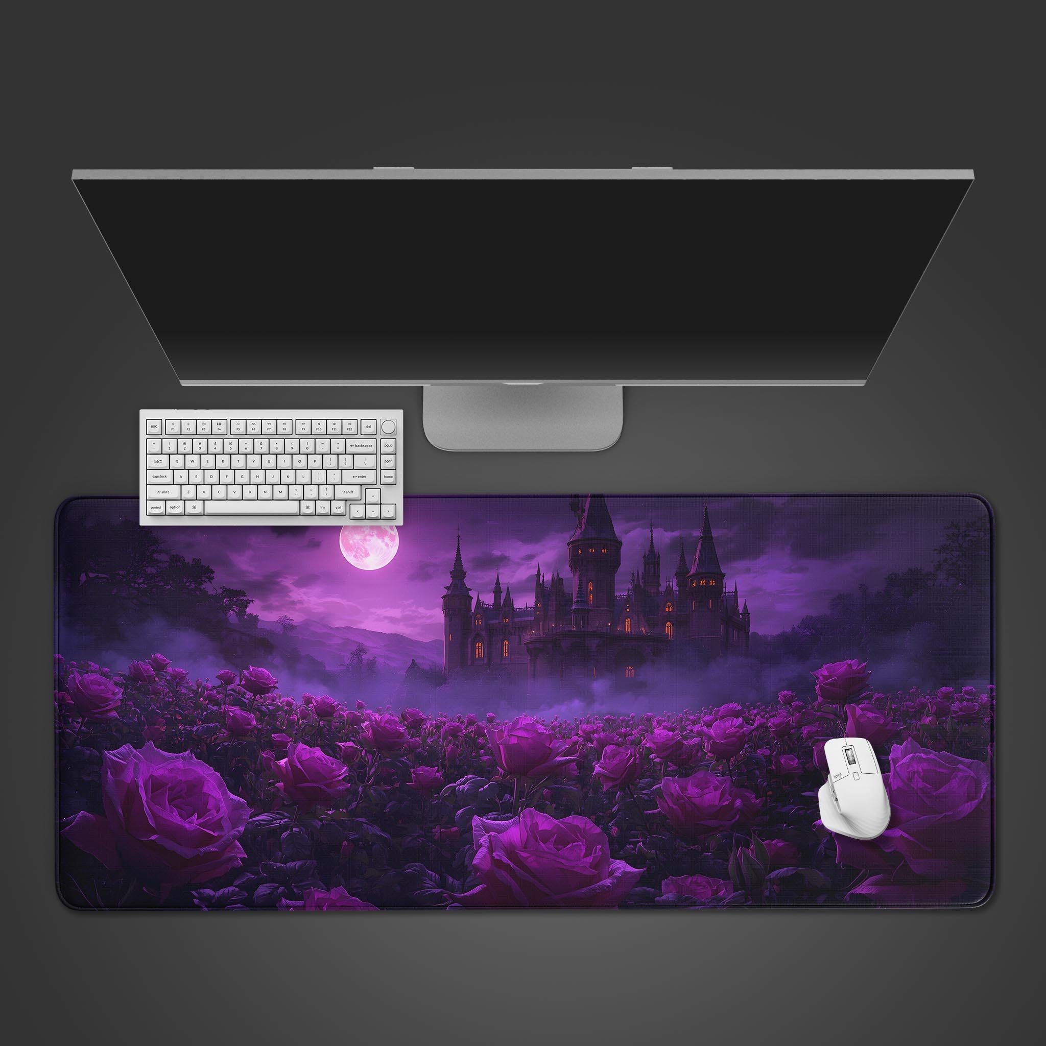 Midnight Roses gothic desk mat with enchanted castle design. Top-down view on a desk with a black keyboard and purple backlit mouse. - Epic Design Pads & Mousepads