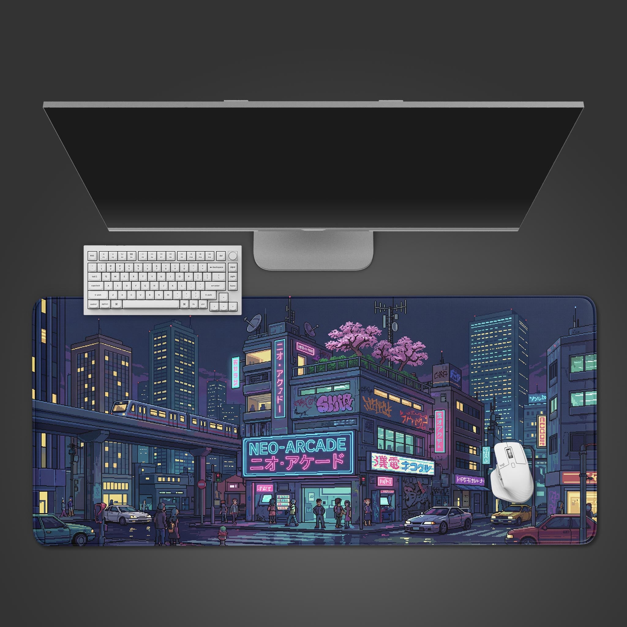 Top-down view of the Midnight Transit gaming desk mat, featuring a pixel art cityscape, with a white keyboard, mouse, and large monitor. - Epic Design Pads & Mousepads