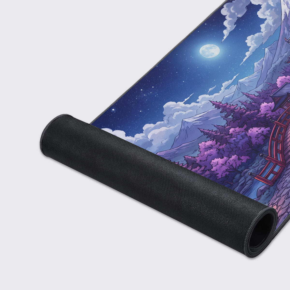 Detail of the desk mat displaying a full moon in a starry night sky above a traditional Japanese pagoda.