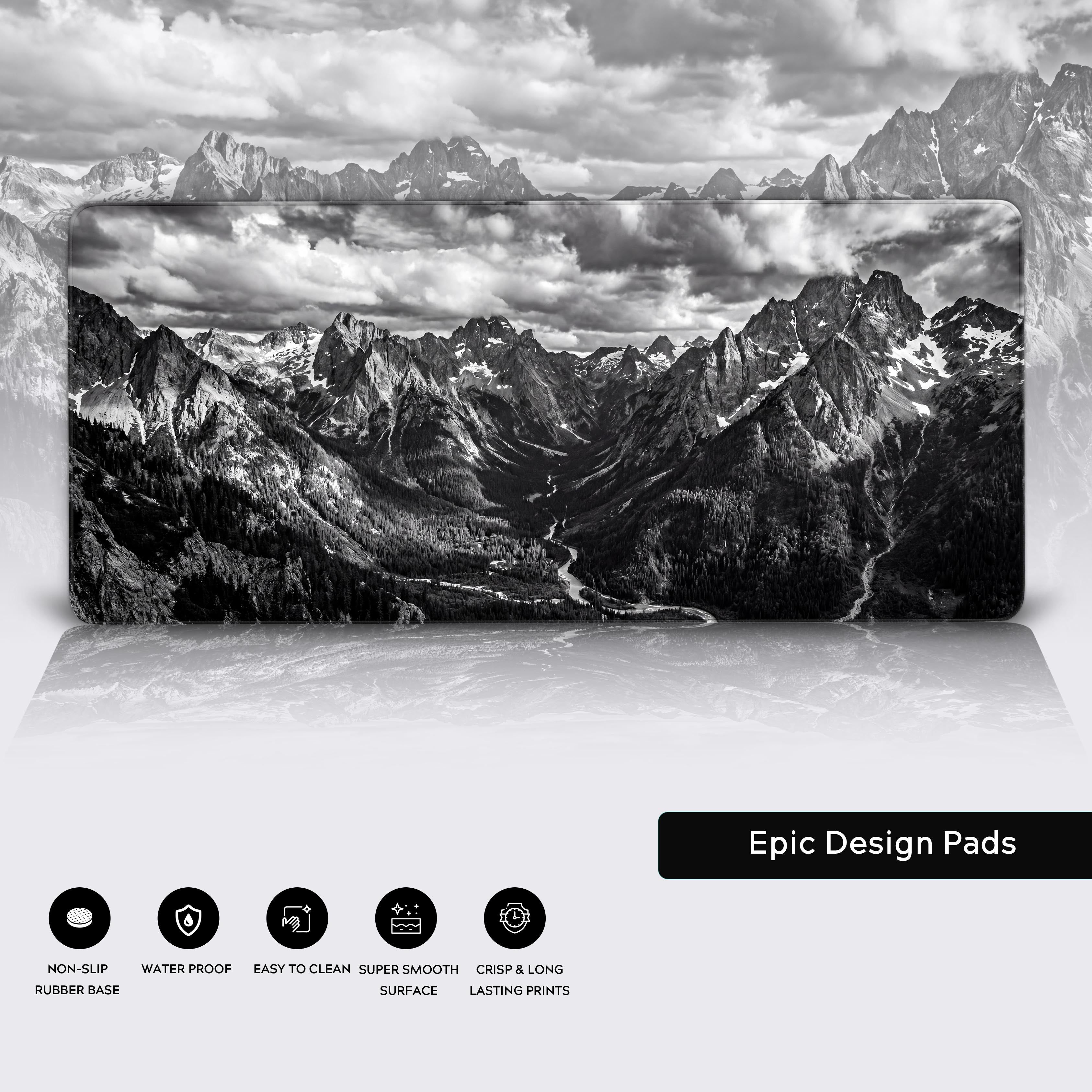 A moody minimalist desk setup featuring the black and white mountain photography extra large mousepad.