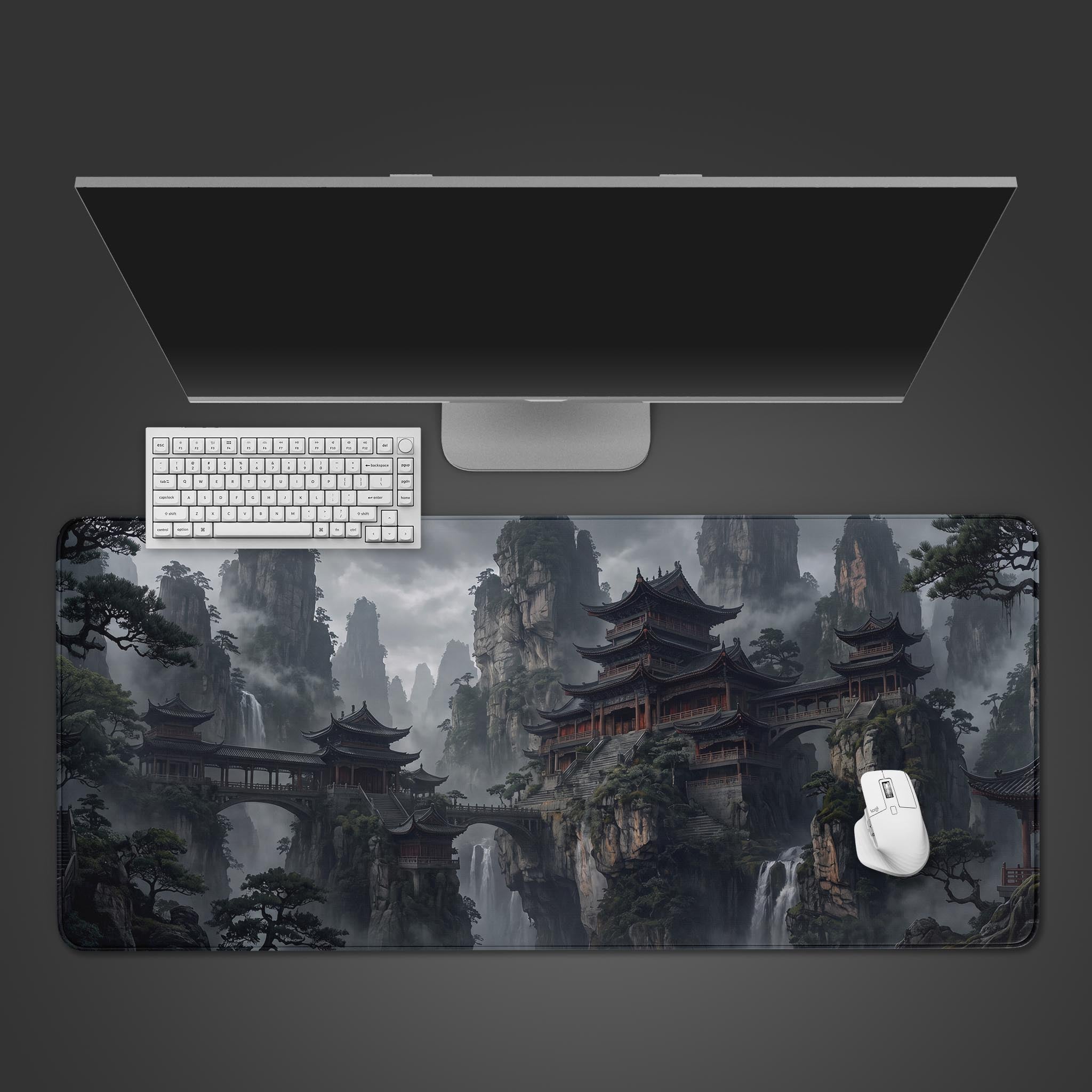 A desk mat showcasing an epic, misty mountain landscape with elaborate ancient pagodas, stone bridges, and waterfalls.