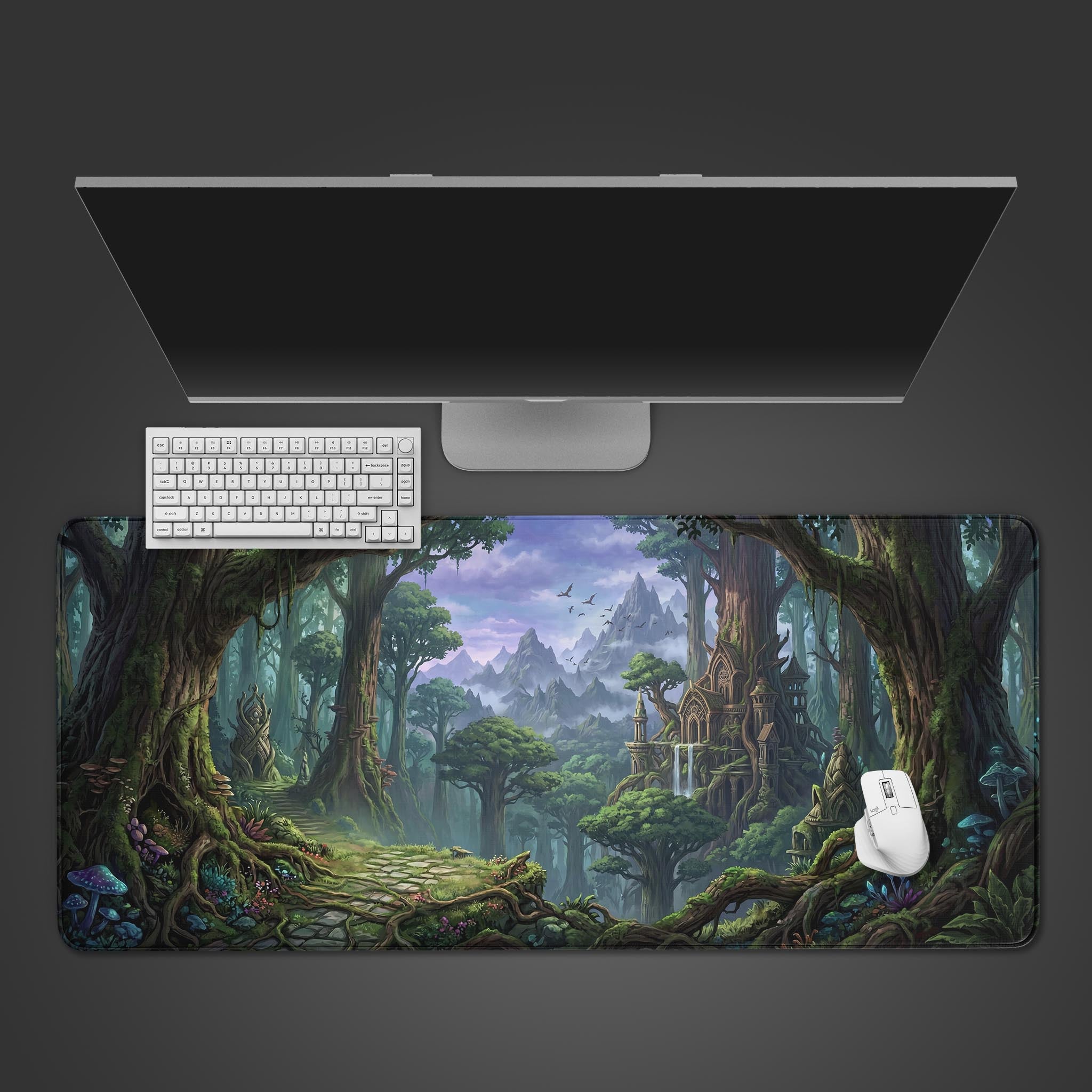 Top-down view of the Mystic Woodlands gaming desk mat, showcasing its enchanted forest design under a white keyboard and mouse next to a computer monitor. - Epic Design Pads & Mousepads