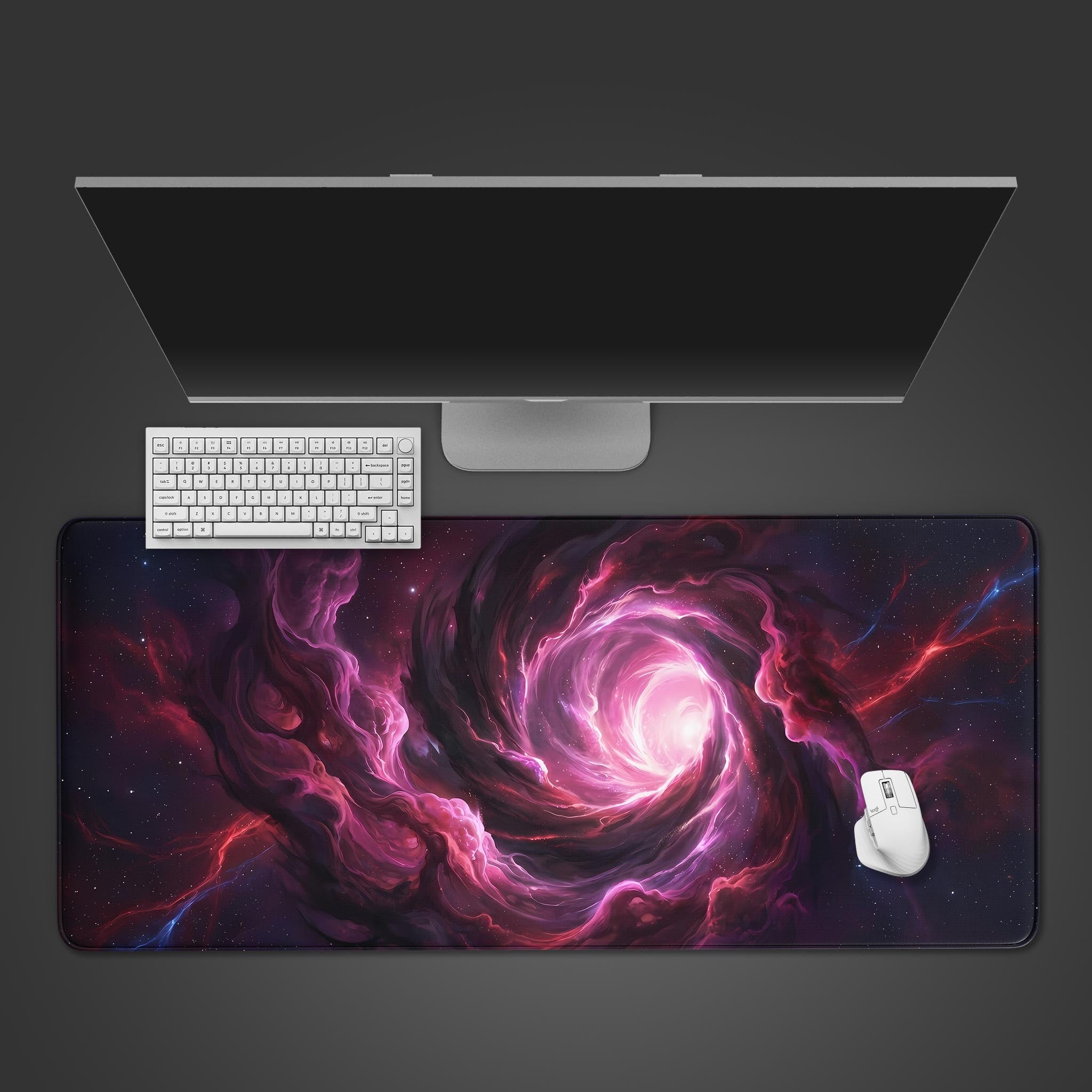 A top-down view of the Nebula Core gaming desk mat, featuring a white keyboard and mouse under a sleek monitor, showcasing the mat's vibrant purple and pink cosmic design. - Epic Design Pads & Mousepads