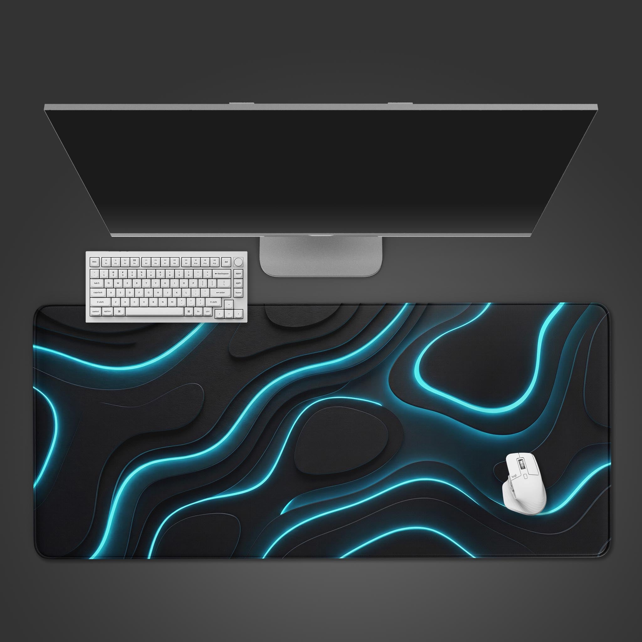Top-down view of the Neon Topography gaming desk mat, showing its glowing blue lines under a monitor, with a white keyboard and mouse. A sleek and modern desk setup. - Epic Design Pads & Mousepads