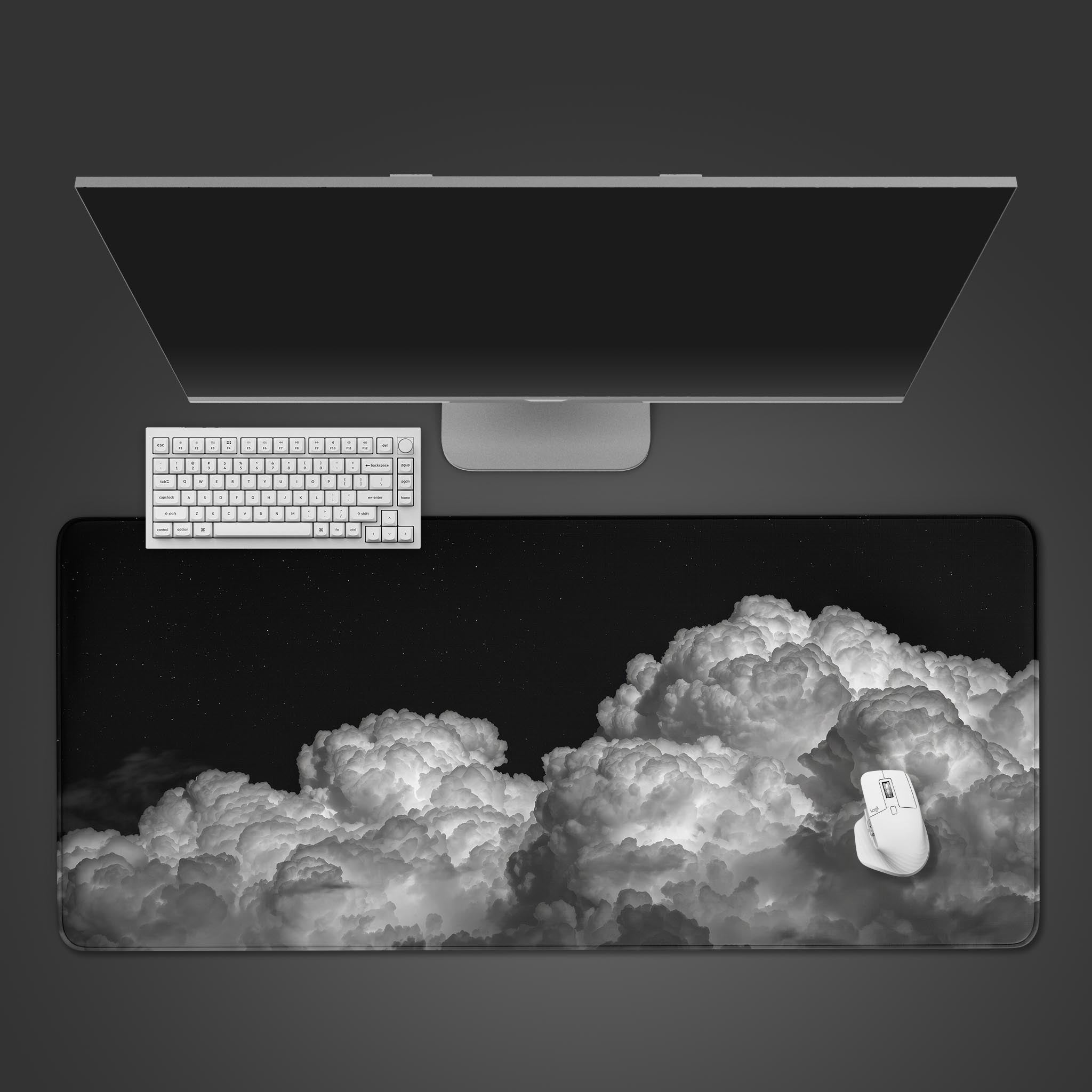 Night Bloom desk mat with a monochrome cloudscape design, shown from a top-down desktop view with a black keyboard and mouse. - Epic Design Pads & Mousepads