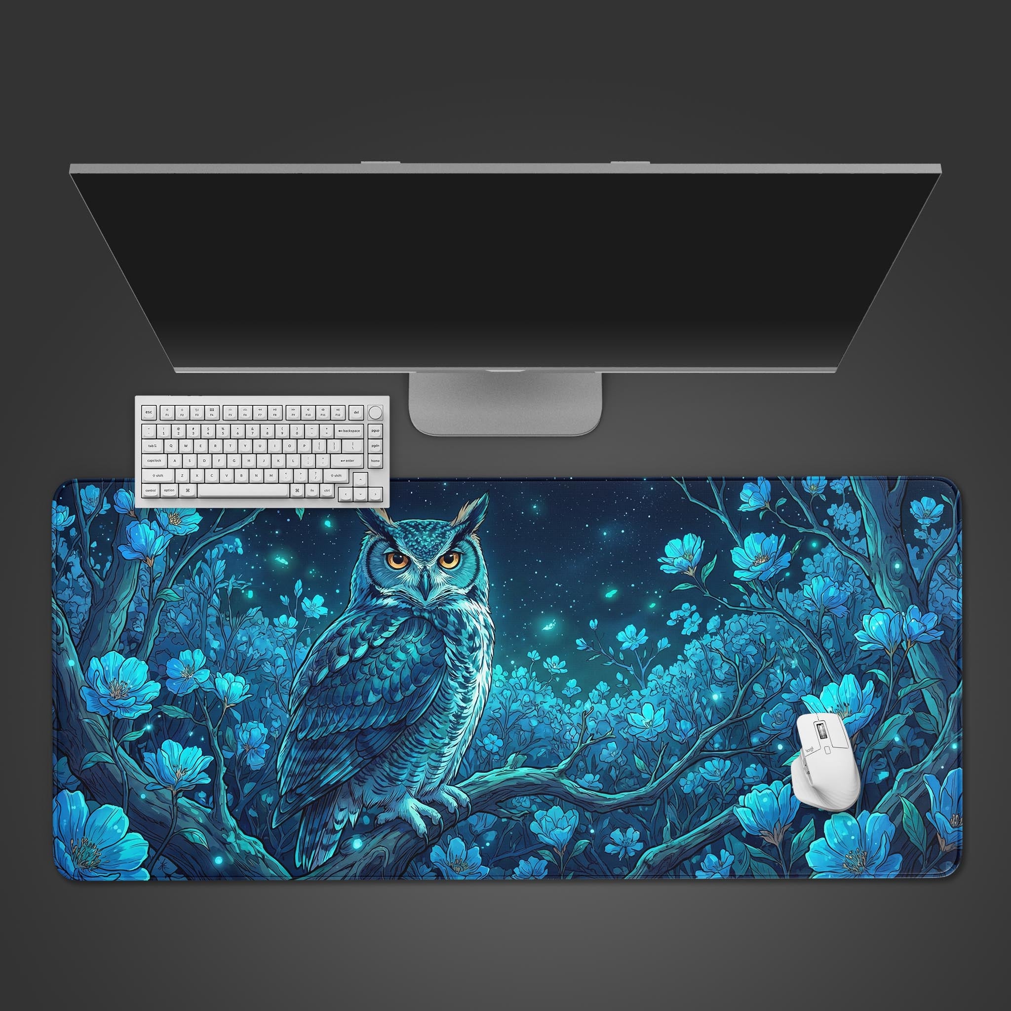 Top-down view of the Nocturnal Wisdom gaming desk mat featuring a blue owl design, shown with a white keyboard, mouse, and monitor on a dark background. - Epic Design Pads & Mousepads