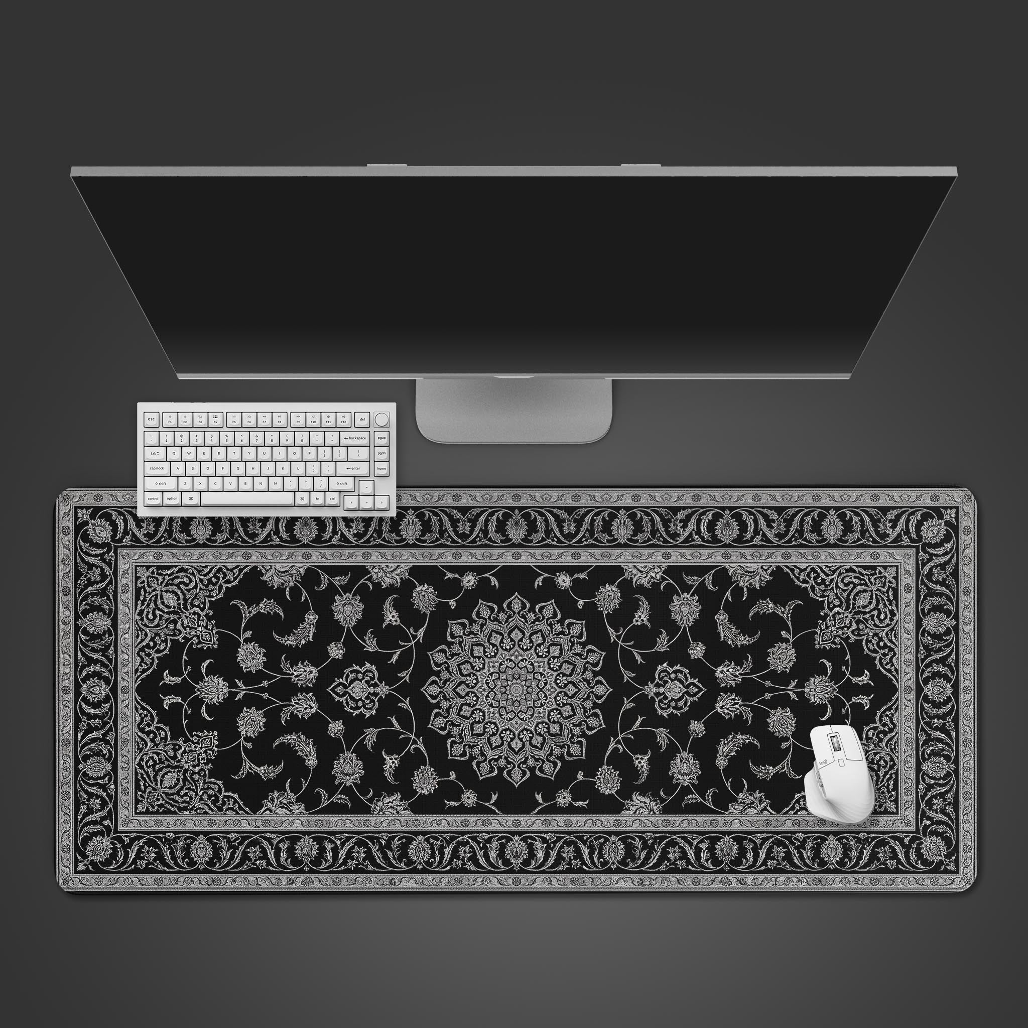 Top-down view of the Noir Tapestry gaming desk mat, featuring an intricate black and white Persian design, shown with a white keyboard and mouse. - Epic Design Pads & Mousepads