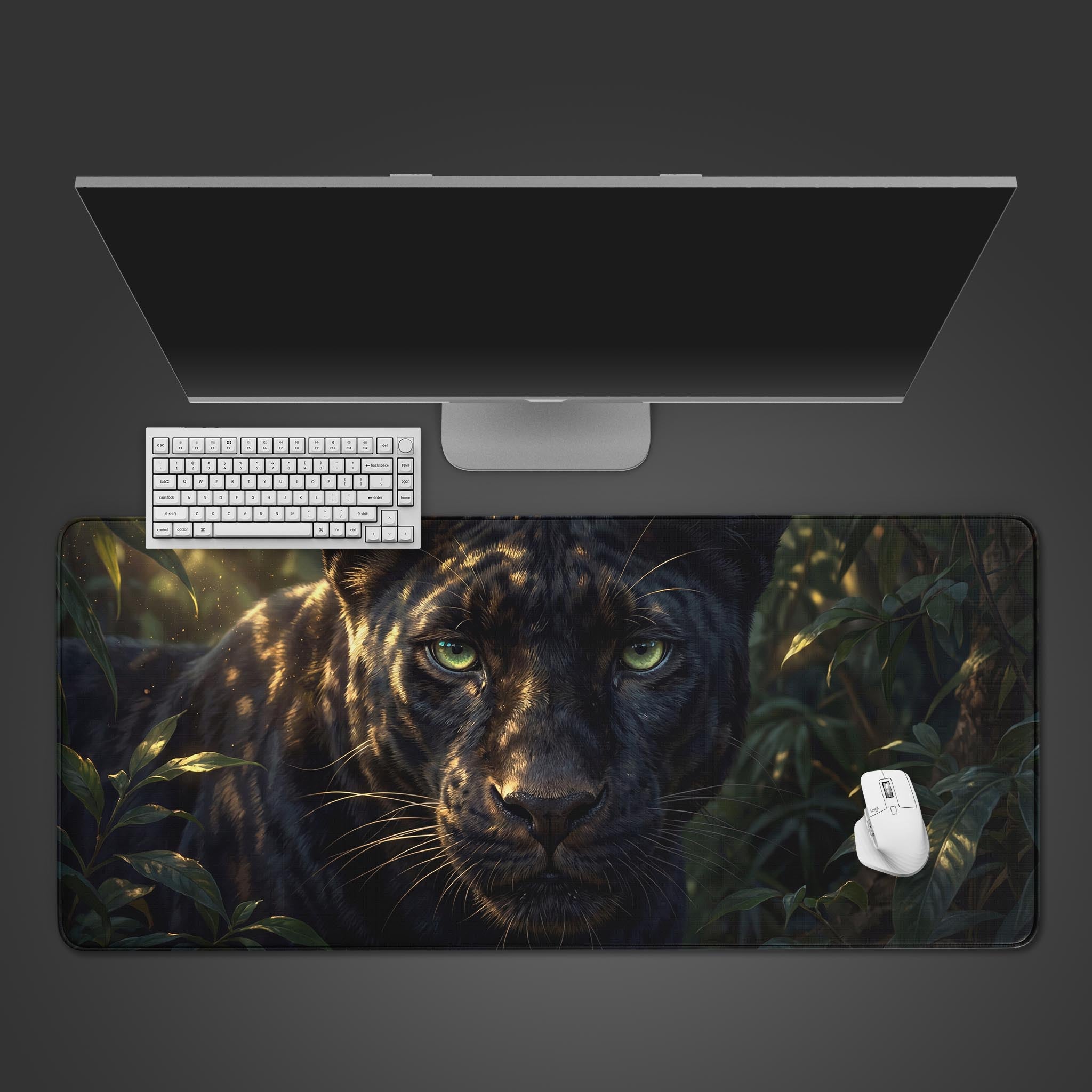 The 'Obsidian Shadow Sentinel' gaming desk mat, featuring a black panther design, shown from a top-down view with a white keyboard, mouse, and a large monitor on a dark background. - Epic Design Pads & Mousepads