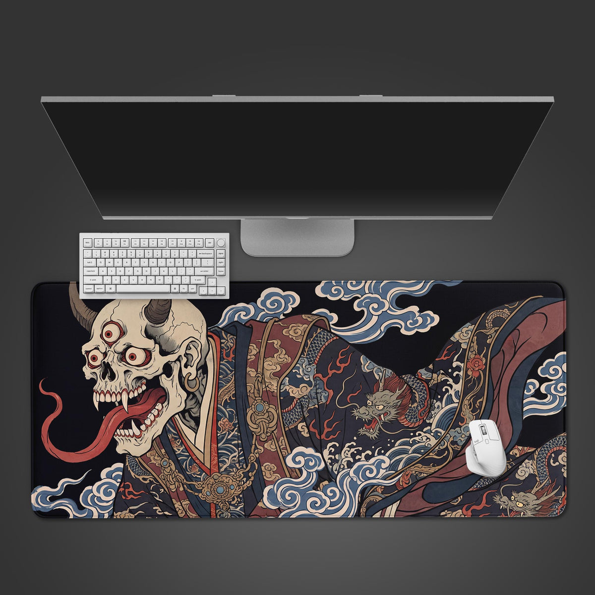Top view of an oni skull japanese desk mat: three-eyed horned skull in dragon kimono, white keyboard, mouse and monitor