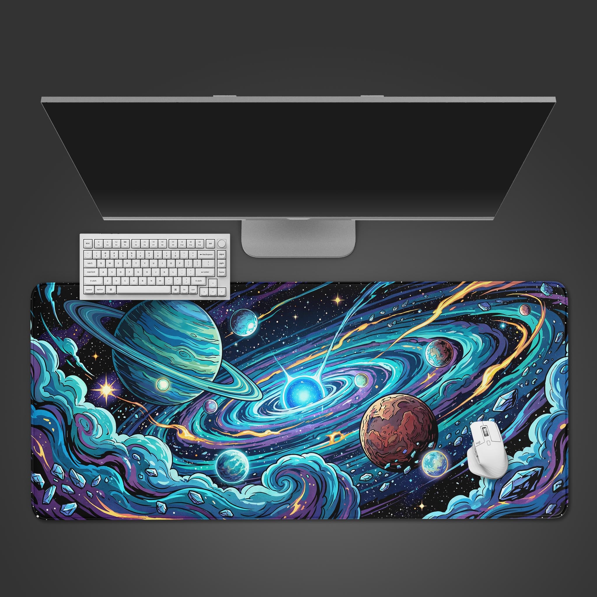 Top-down view of the Orbital Chaos gaming desk mat featuring a vibrant galaxy and planets, shown with a white keyboard, mouse, and monitor on a dark background. - Epic Design Pads & Mousepads