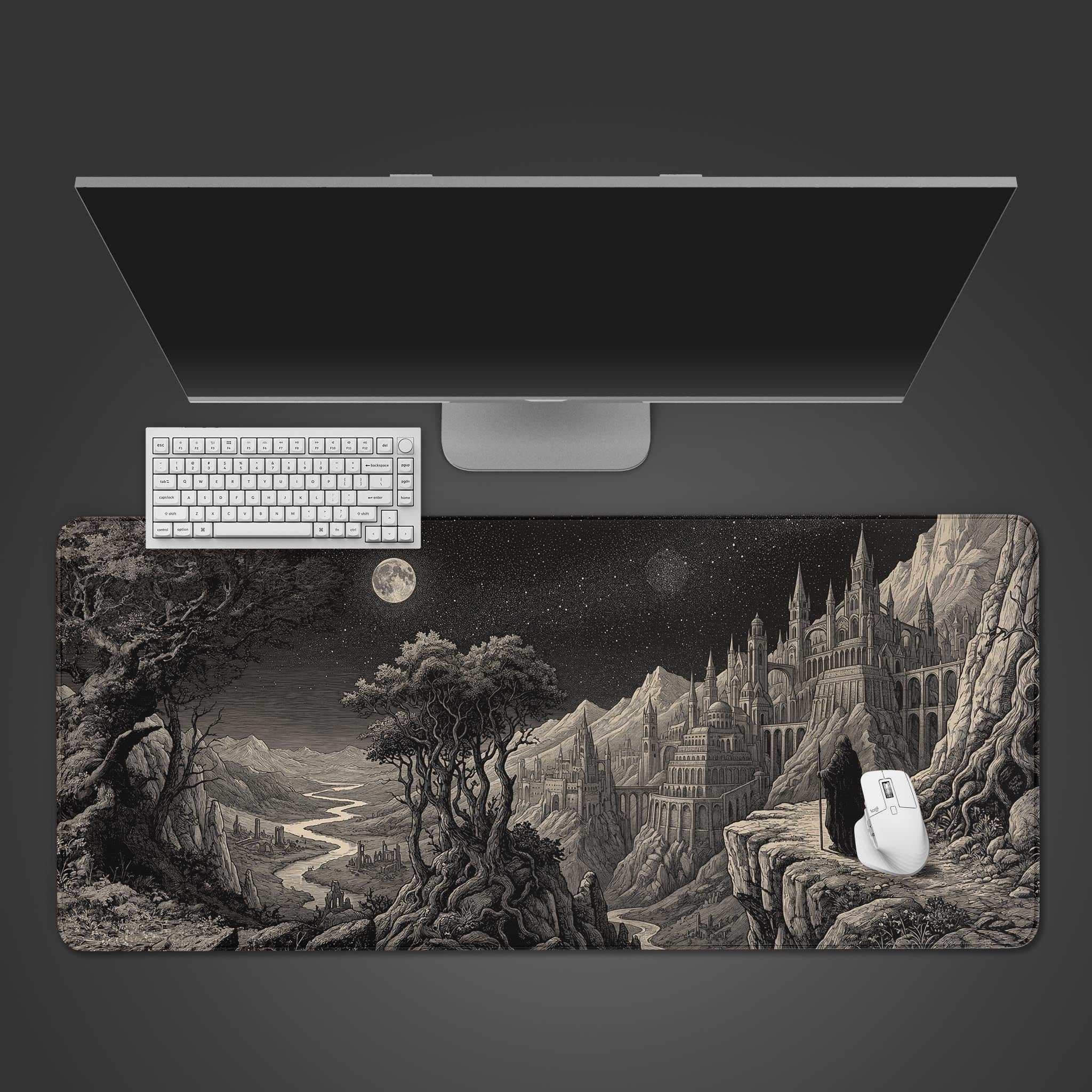 A top-down view of the Pilgrim's Precipice Gaming Desk Mat, featuring its monochrome fantasy castle design, with a white keyboard and mouse placed on top. - Epic Design Pads & Mousepads