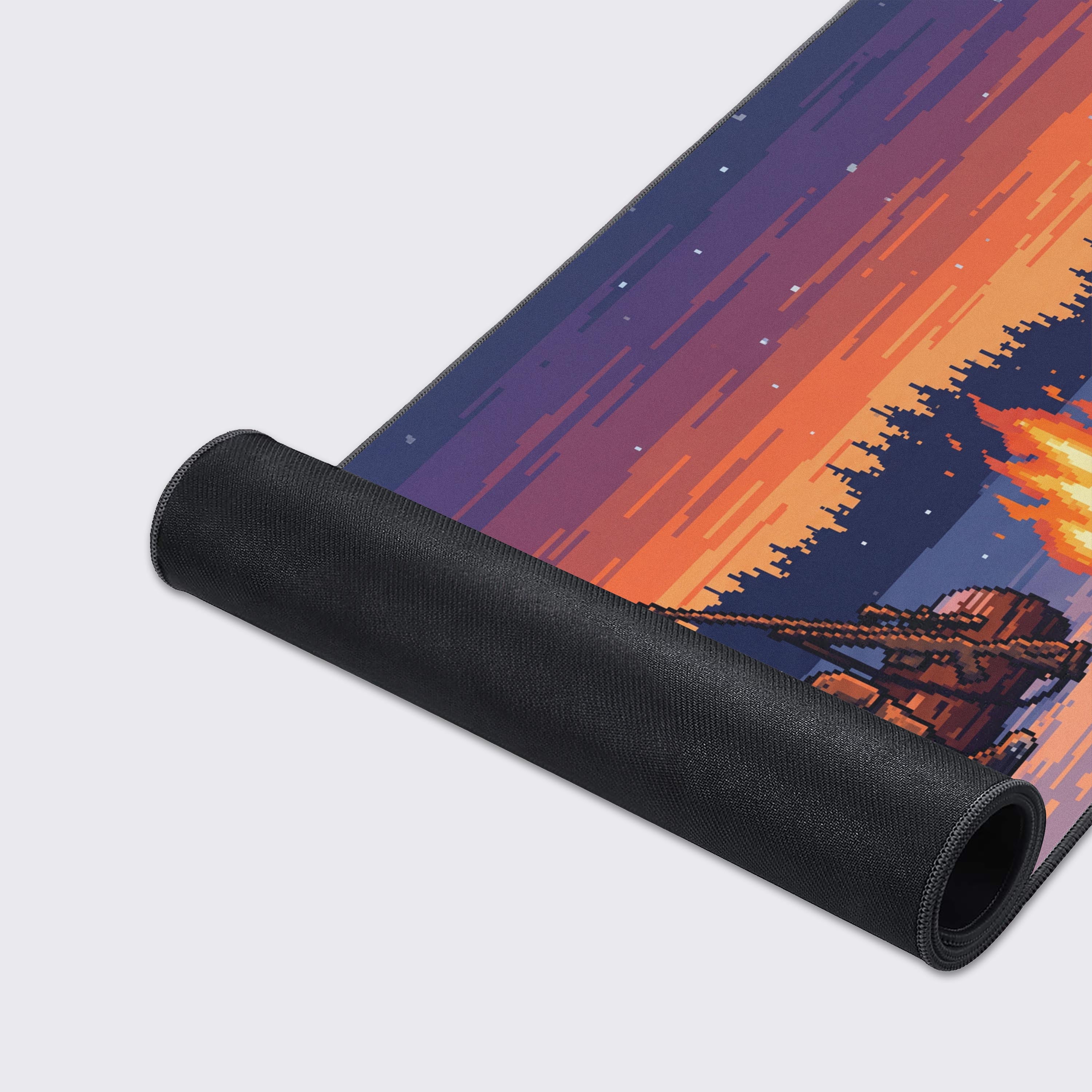 Detail of the snowy pixel art pine forest and small cabin in the background of the desk mat design.
