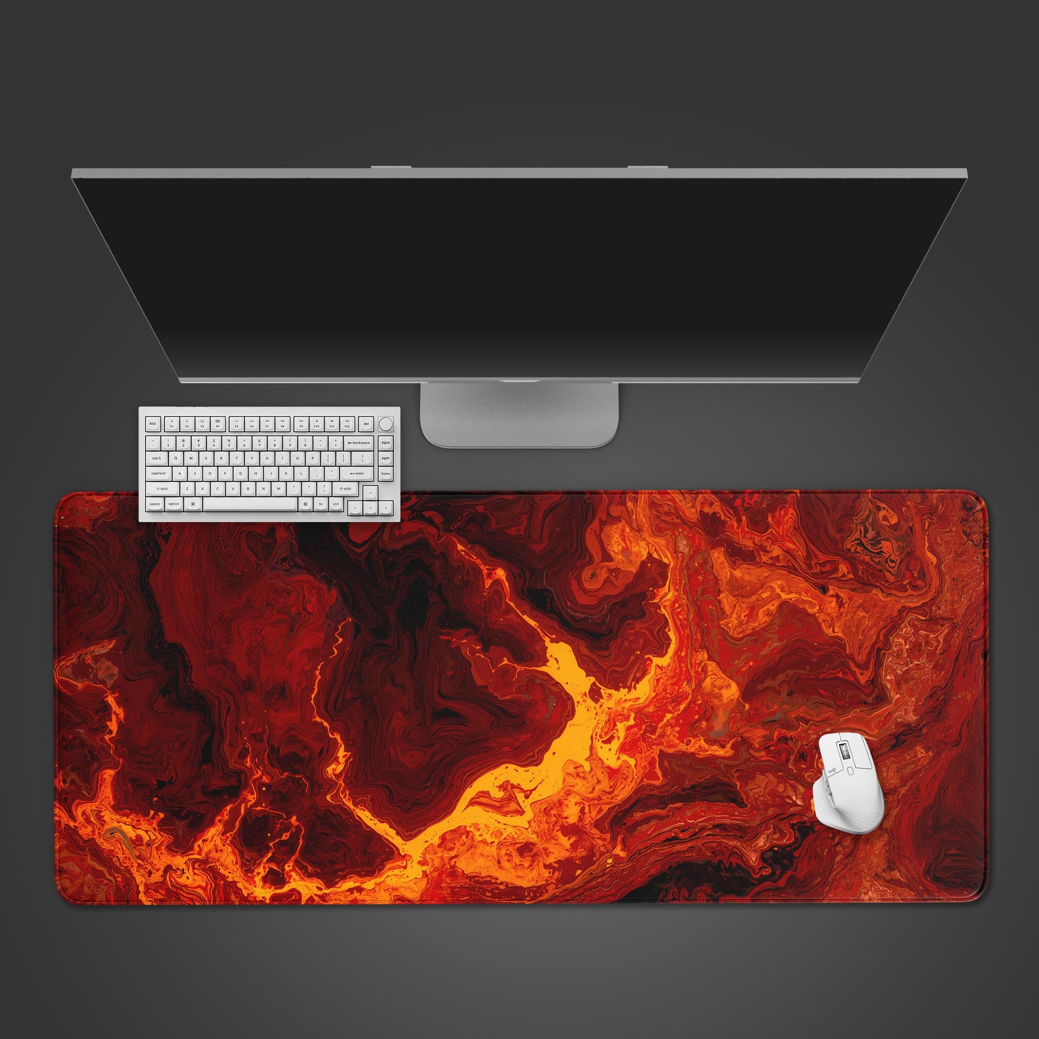 Top-down view of the Primal Flow gaming desk mat. The molten lava design is shown on a desk with a black keyboard and mouse, highlighting its large surface area. - Epic Design Pads & Mousepads