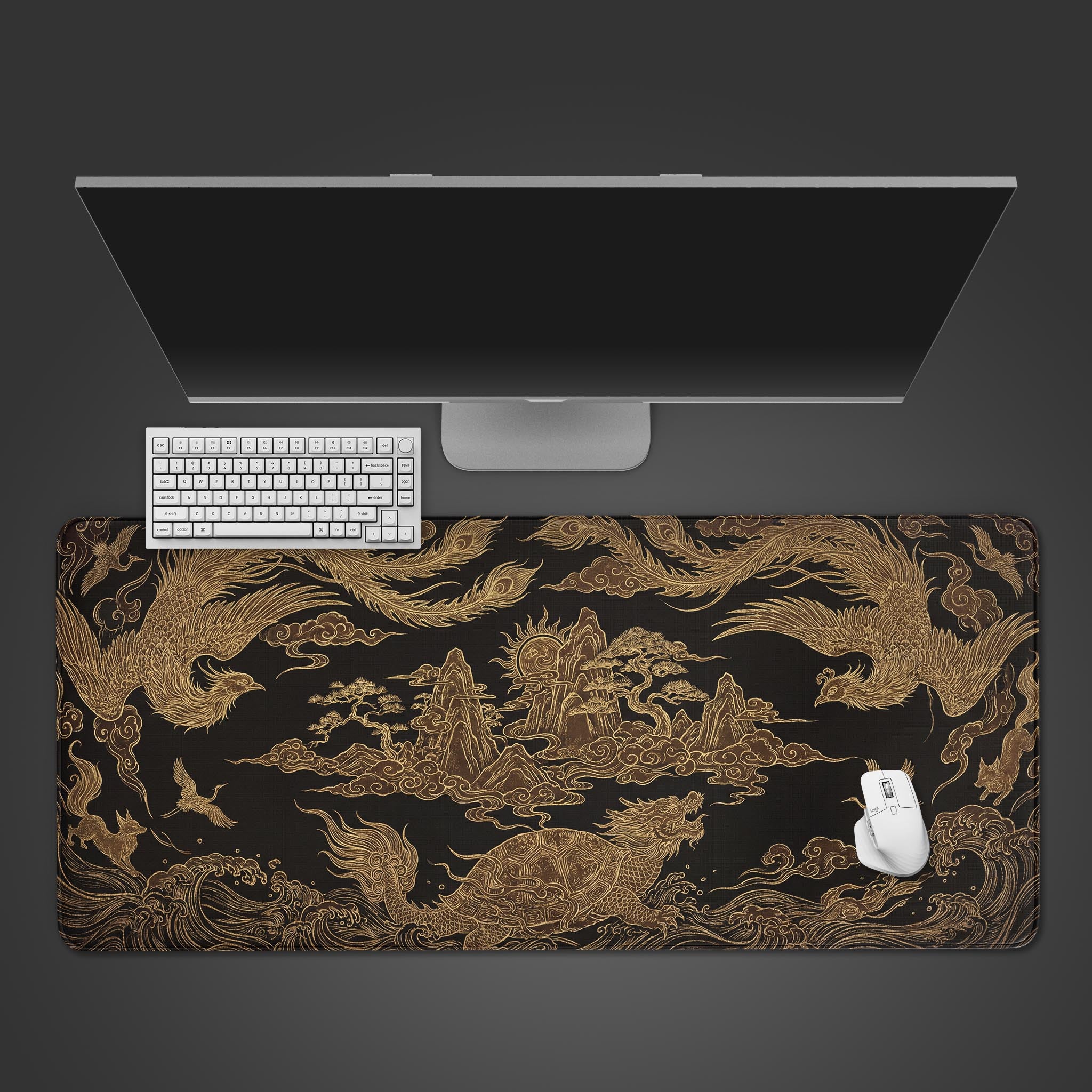 Top-down view of the Prosperity Weave gaming desk mat featuring gold Chinese dragons and phoenixes, shown with a white keyboard, mouse, and a large monitor on a dark background. - Epic Design Pads & Mousepads