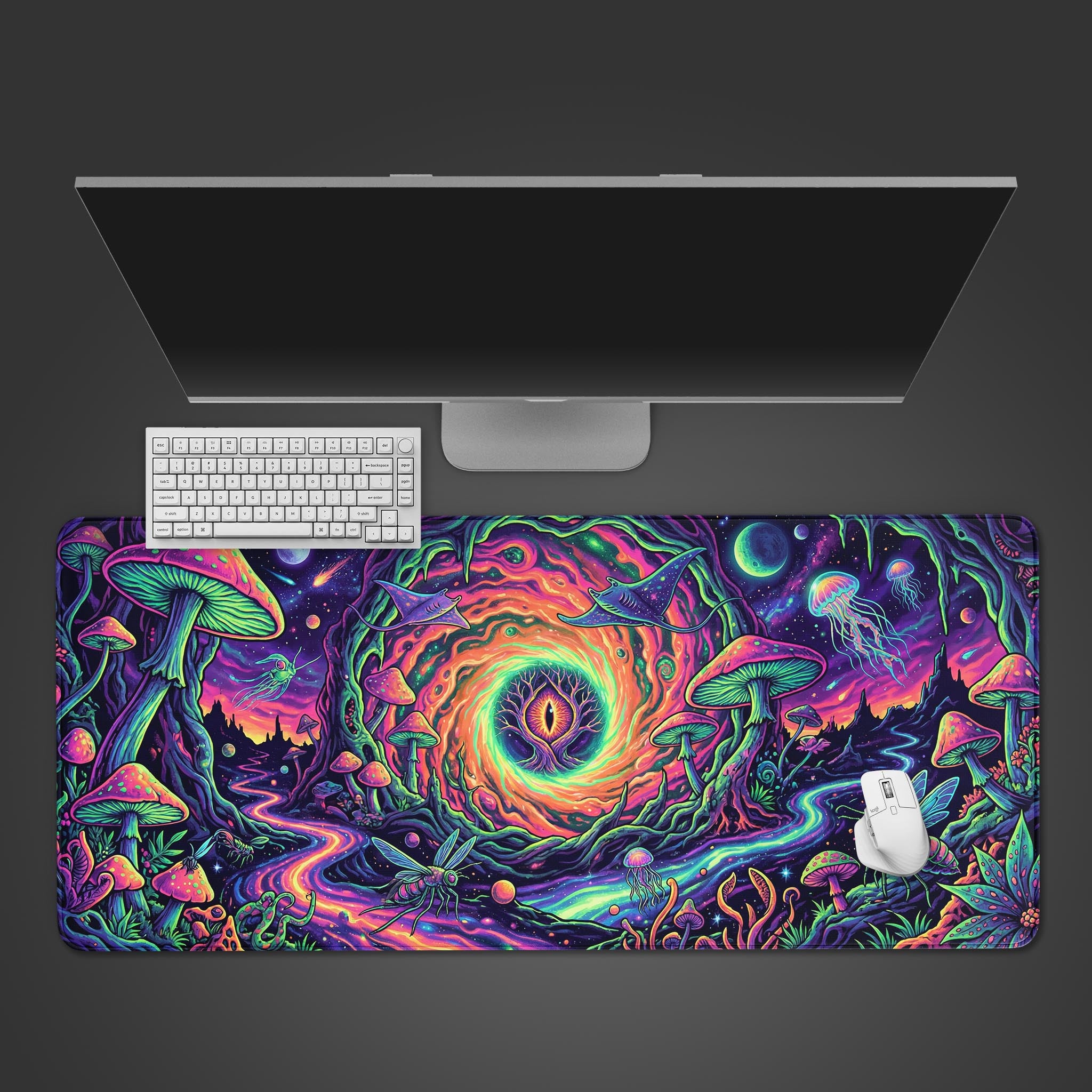 A top-down view of the Psychedelic Realm gaming desk mat featuring a vibrant mushroom forest and cosmic eye, shown with a white keyboard and mouse on a dark surface. - Epic Design Pads & Mousepads