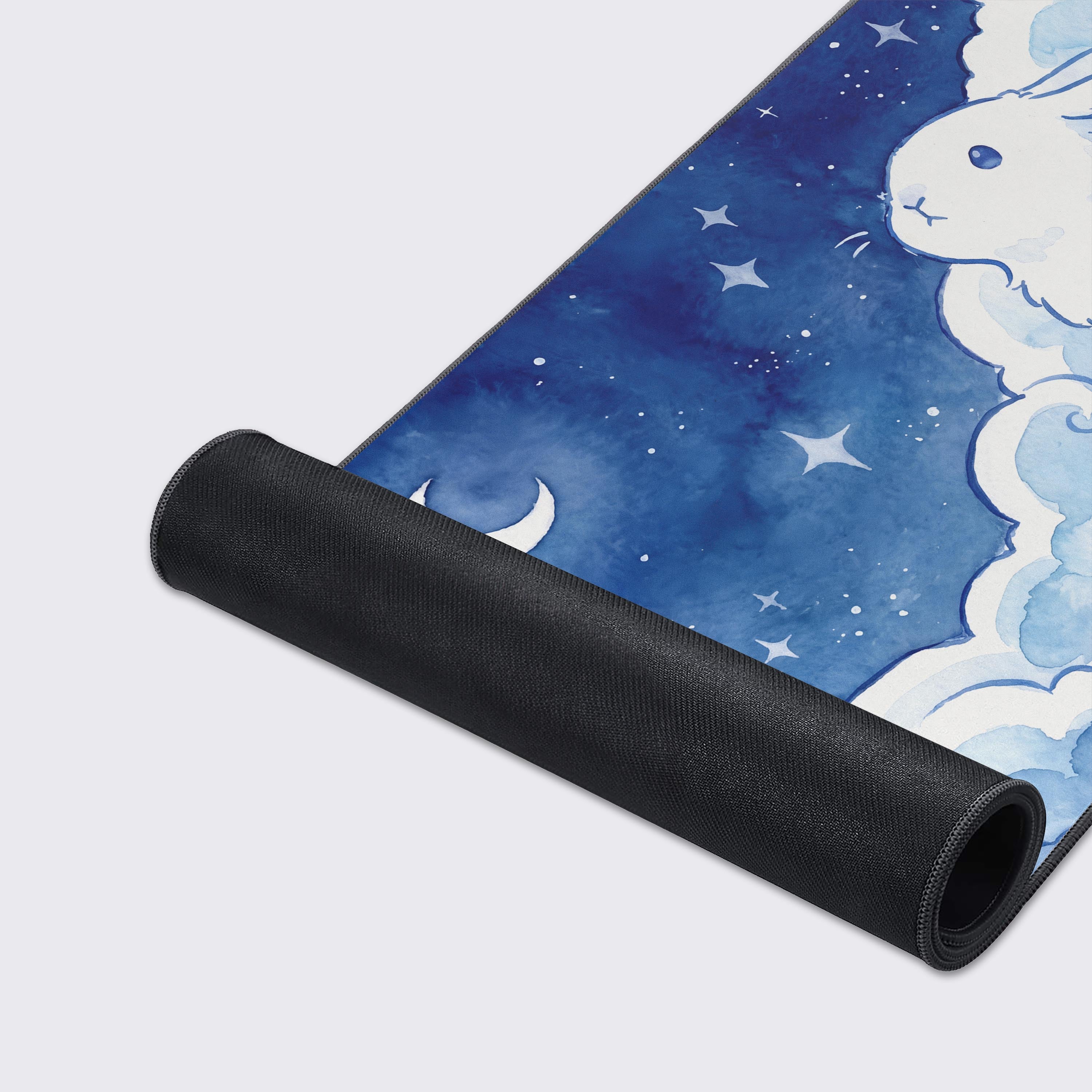 Extended gaming mouse pad with adorable rabbit artwork and blue celestial aesthetic over a reflective surface.