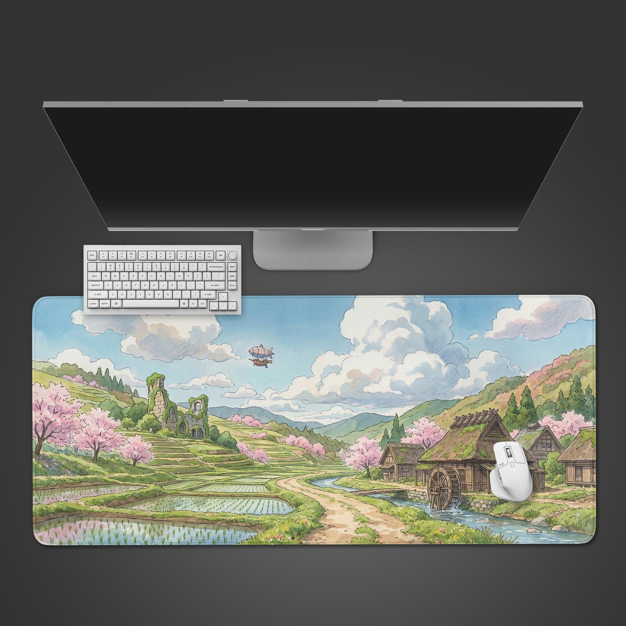 A watercolor style desk mat featuring a pastoral landscape with rice terraces, a watermill, and cherry blossoms.