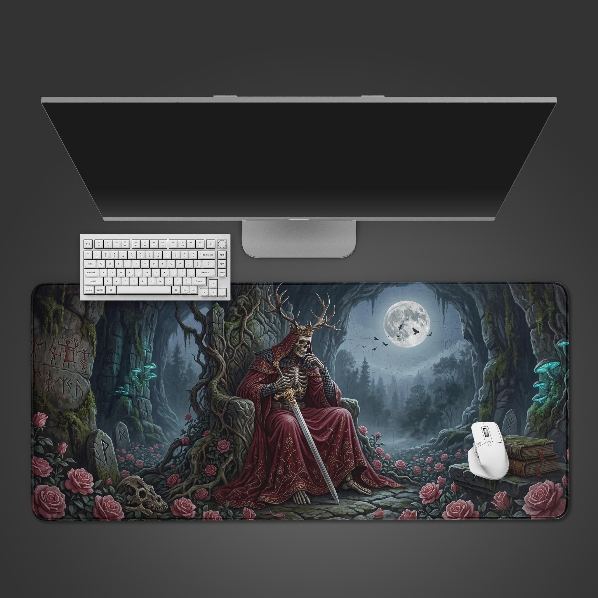 Top-down view of the Rose King Throne gaming desk mat, showing the skeleton king design beneath a sleek monitor, white keyboard, and mouse. - Epic Design Pads & Mousepads