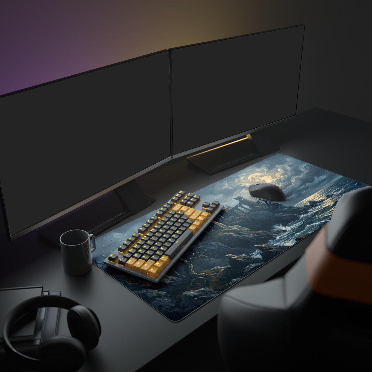 Desk mat on a dark desk with two monitors, keyboard, mug and headphones, showing moonlit castle ruins above stormy waves