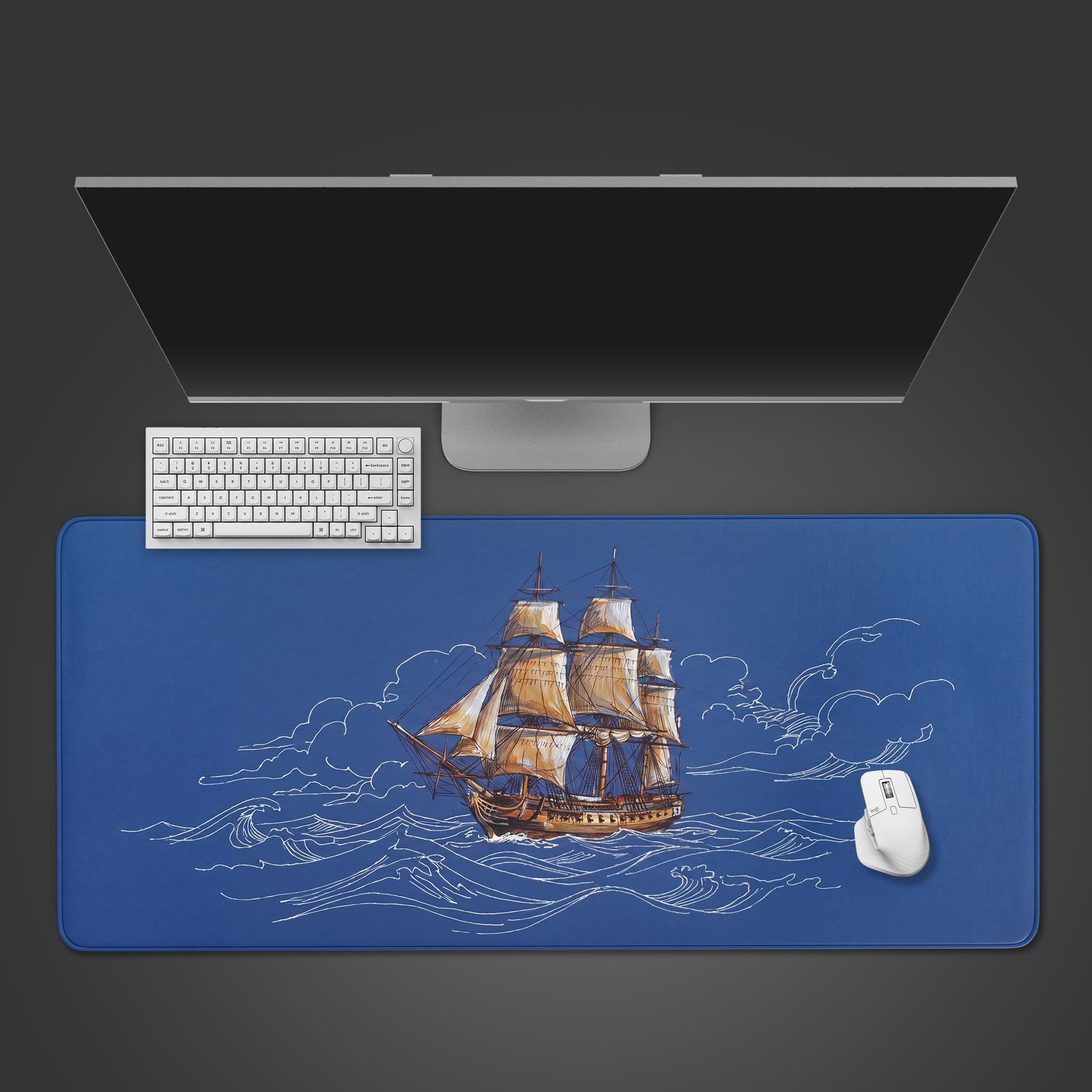 A blue desk mat featuring a vintage sailing ship with white blueprint style ocean waves.
