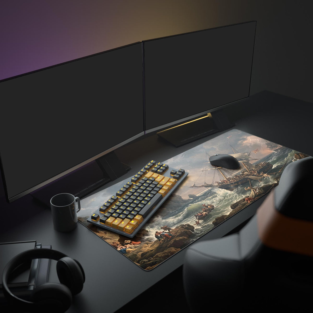 Desk mat on a dark desk with two monitors, keyboard, mug and headphones; ship in crashing waves beside a rocky shore